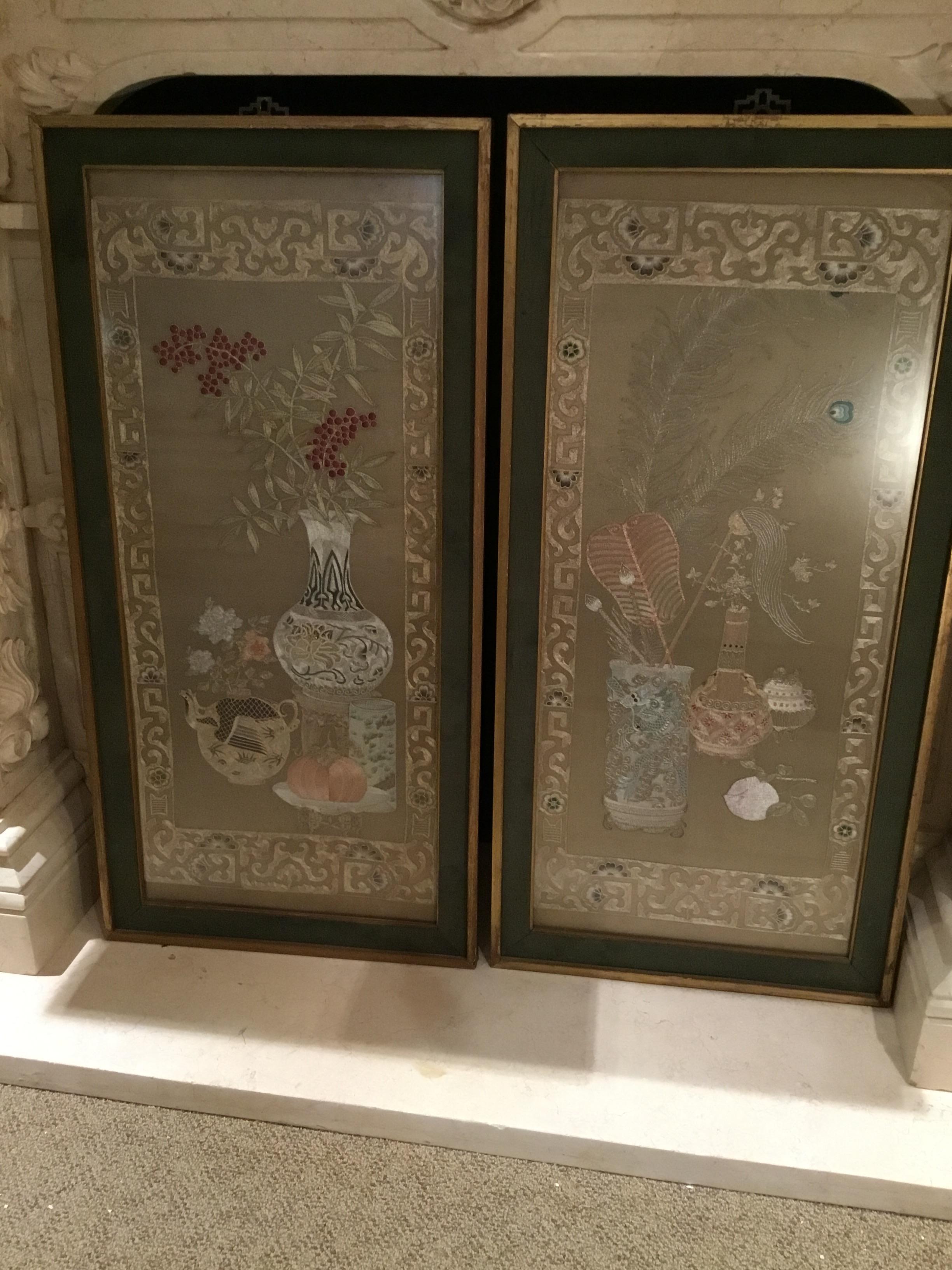 Handsome pair with intricate stitching. One depicting a vase of peacock feathers and the
Other a vase of bamboo and a teapot, in giltwood frames, with opaque glass covering.
Mounted on silk background.