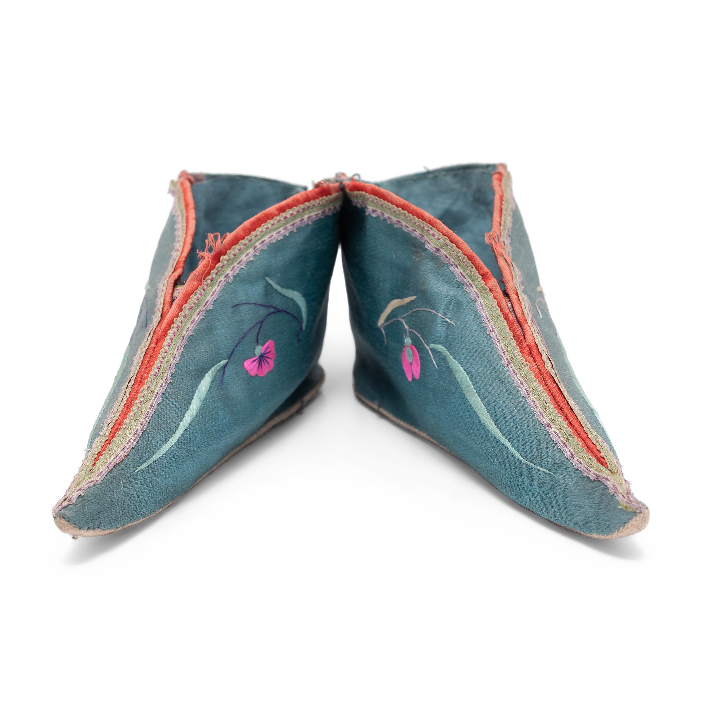 These dainty, pointed slippers, made of blue silk and embroidered with pink flowers, were shaped to resemble a lotus bud and enhanced the diminutive shape of bound feet. A practice that began in the Tang dynasty and reached the height of its
