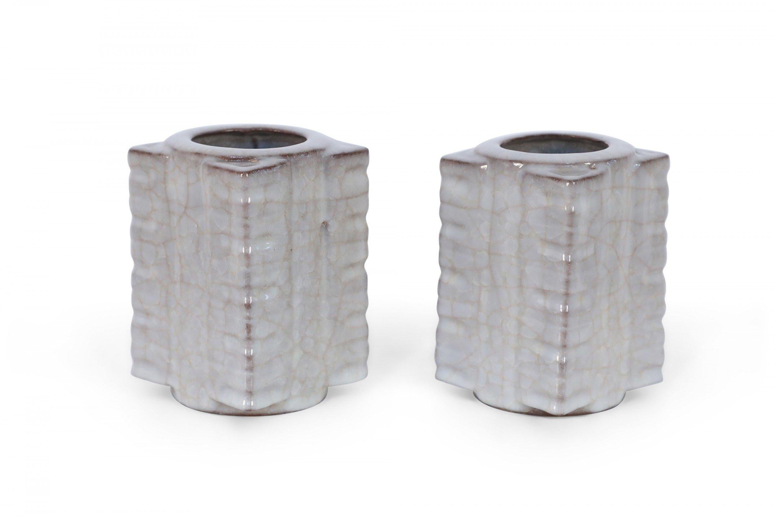 Pair of Antique Chinese Song Dynasty-style vases with traditional cong forms, beige crackle finishes, and round mouths and bases (PRICED AS PAIR).
 
