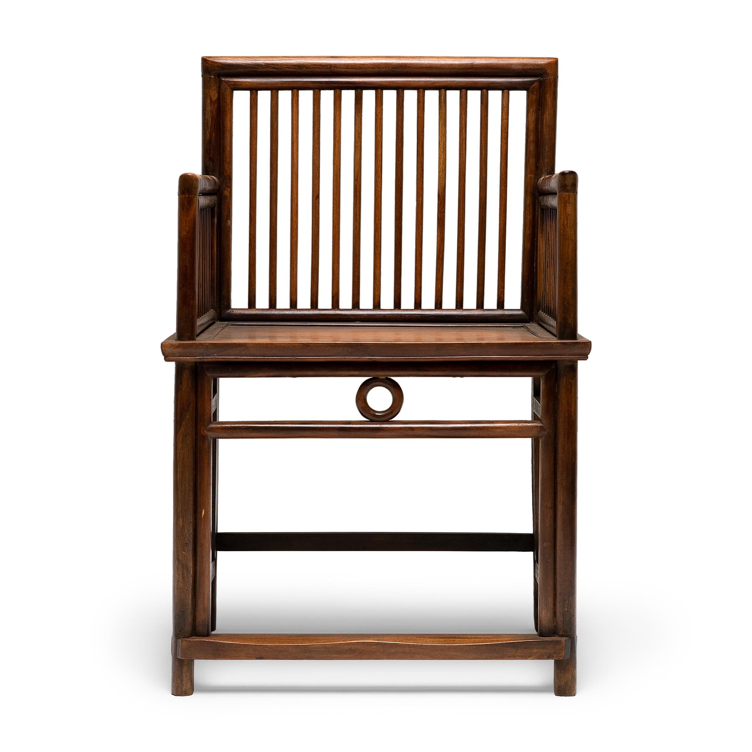 This pair of elegant low-back armchairs date to the late Qing dynasty (1644-1911), designed with spindle-back frames and clean-lined silhouettes. Known as a rose chair (meiguiyi) or writing chair (wenyi), this type of informal seat was traditionally