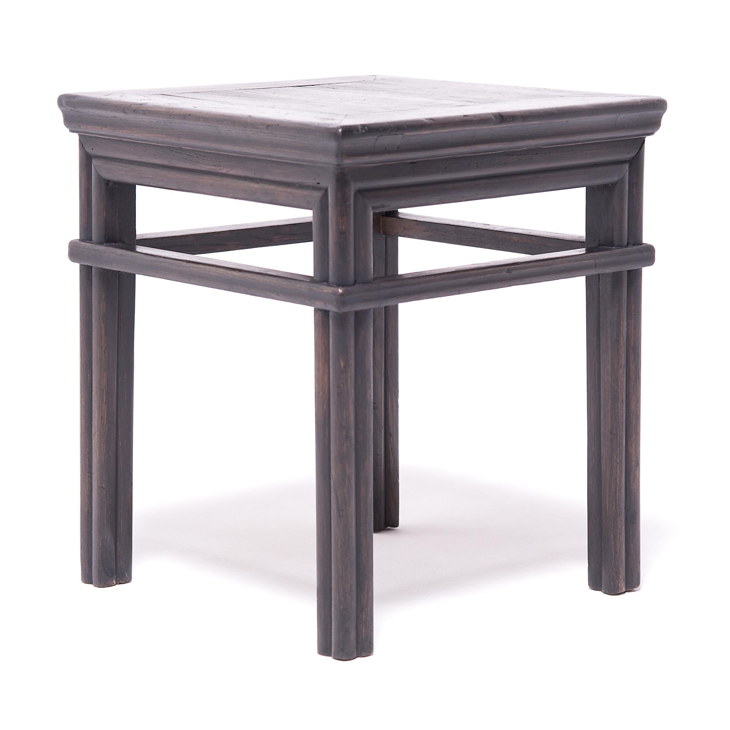 This form of square stool, or fang deng, was a versatile seating option and was pulled up for use at mealtimes or used outdoors in a courtyard or garden. The pair is expertly crafted of northern elm (yumu) with mortise-and-tenon joinery and a dark