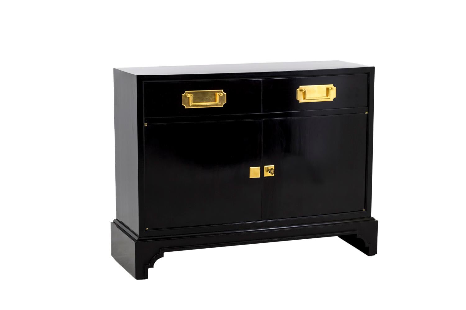 Pair of rectangular shaped black lacquered buffets, opening by one drawer divided in two parts and two-door leaves. Gilt bronze escutcheons and rectangular handles on a cartouche background. Larger leg than the furniture body, slightly opened on the