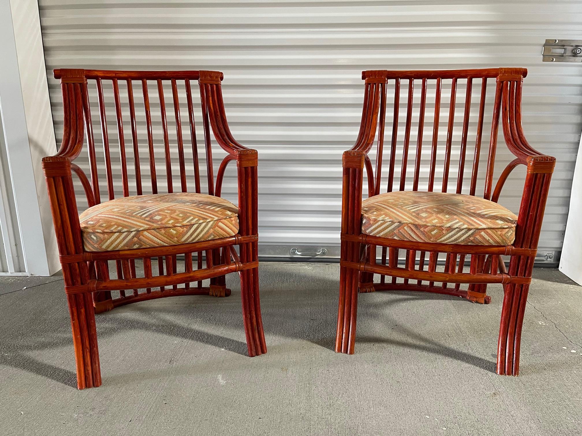 Pair of Chinese style red lacquer rattan chairs created by Maugrion Editions, made in France for Roche Bobois, 20th century. Upholstered cushions.
    