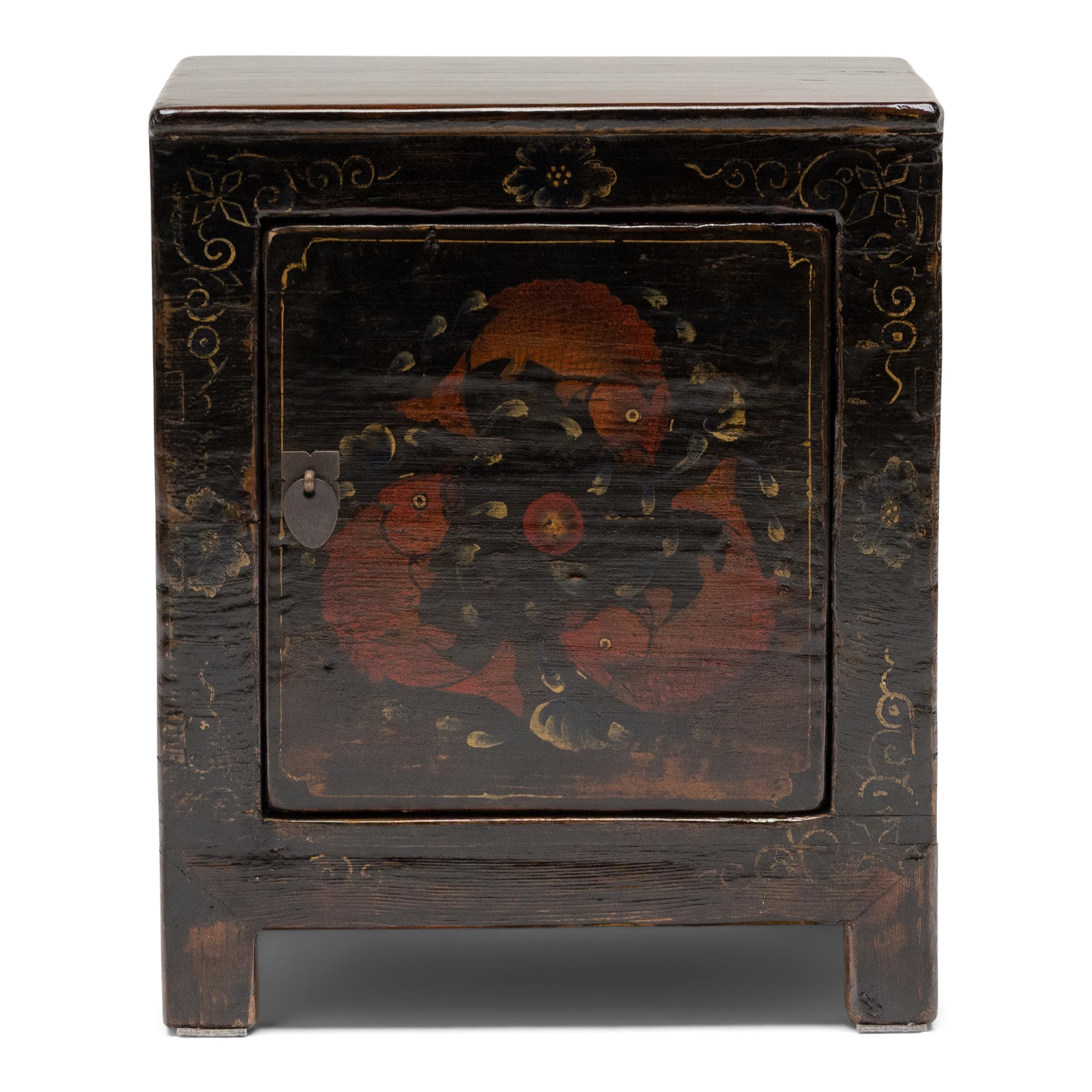 Outlined by a border of flowers and gilt scrollwork, a painted panel of three koi fish adorns the front doors of these early 20th century chests from Shandong province.

This motif of three fish is a visual pun for the 