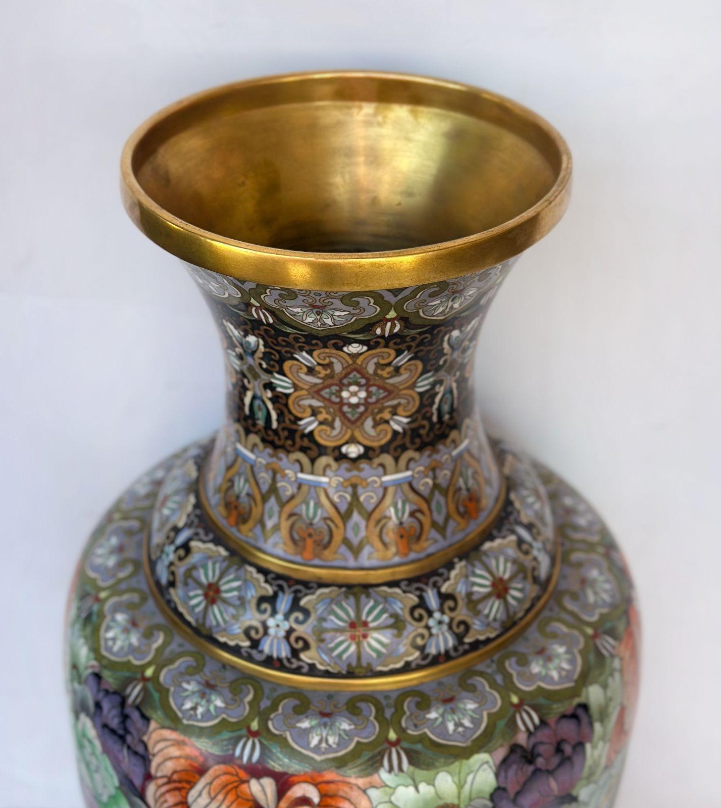 A pair of traditional gold copper Cloisonné vases made in China in the 1980's, each designed all around depicting floral motifs and butterflies, as well as geometric patterns surrounding the piece.
Dimensions:
26