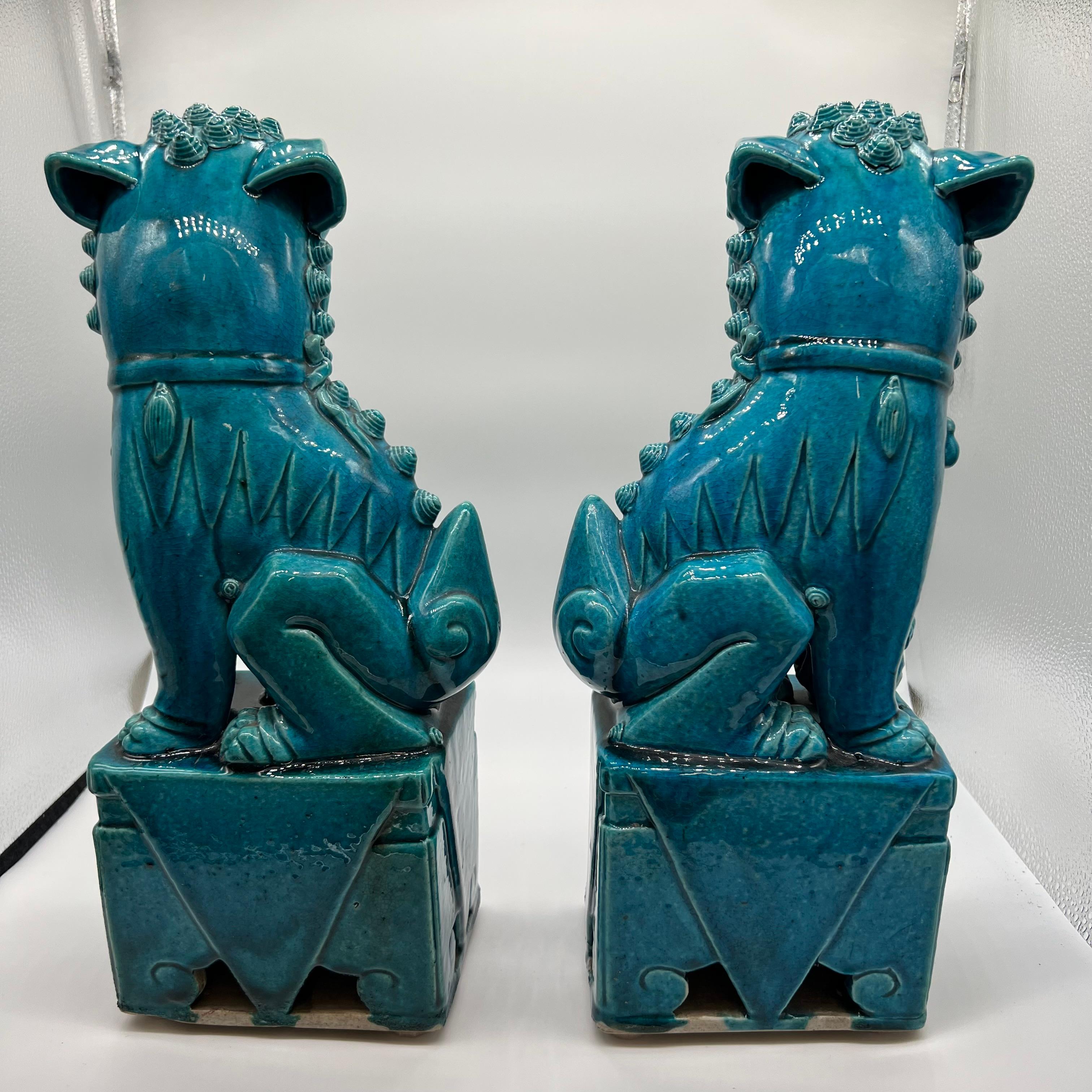A wonderful pair of turquoise glazed Chinese Foo dog statues- circa 1880. Foo dogs were actually lions, yet they resemble a Chow Chow and/or Shih Tzu (dog breeds) which led them to be called foo dogs or fu dogs. Foo dogs were originally displayed