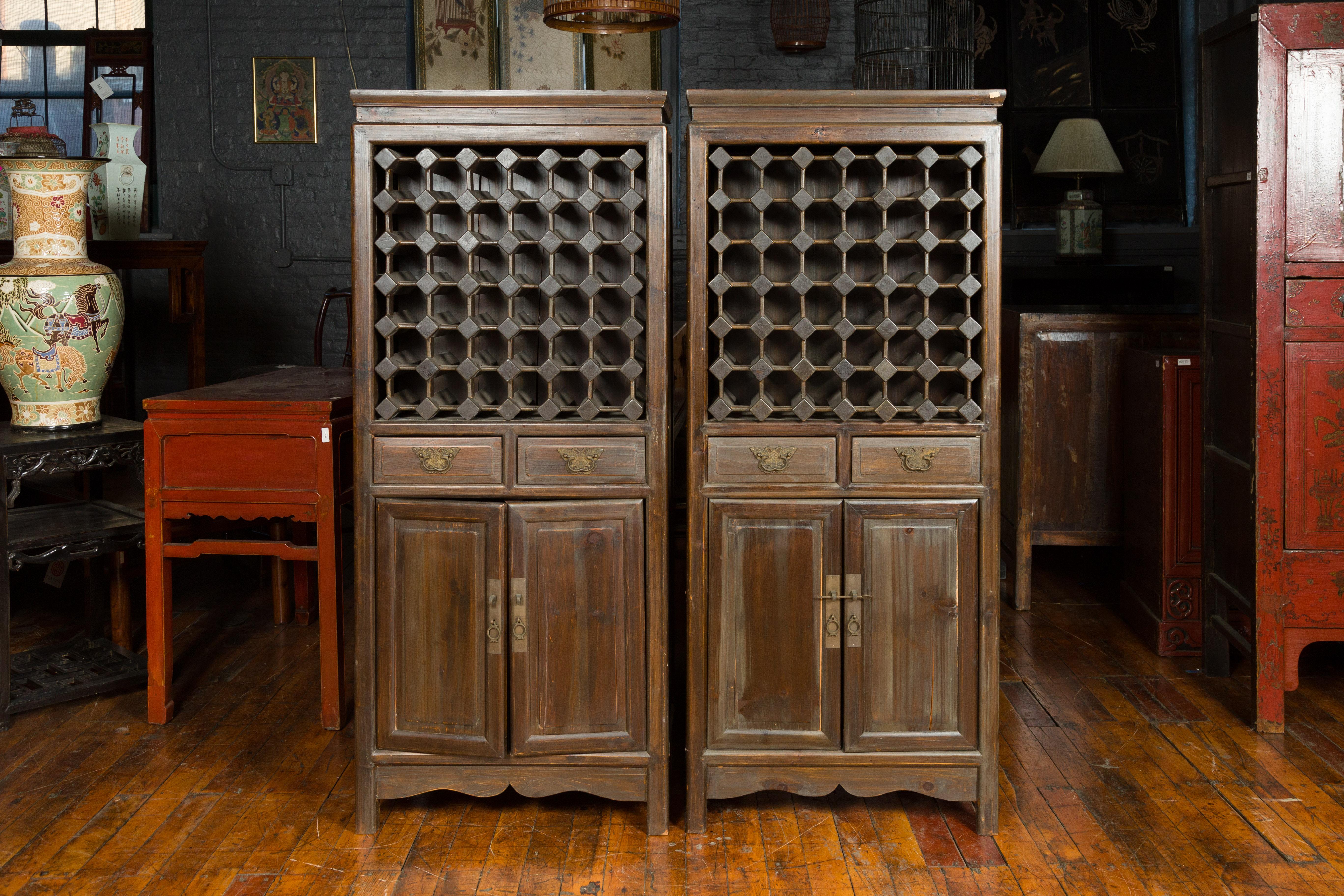 A pair of Chinese vintage cabinets from the mid-20th century, with partitioned removable scroll shelves, drawers and doors. Created in China during the midcentury period, this pair of tall cabinets attracts our attention with its interesting shelves