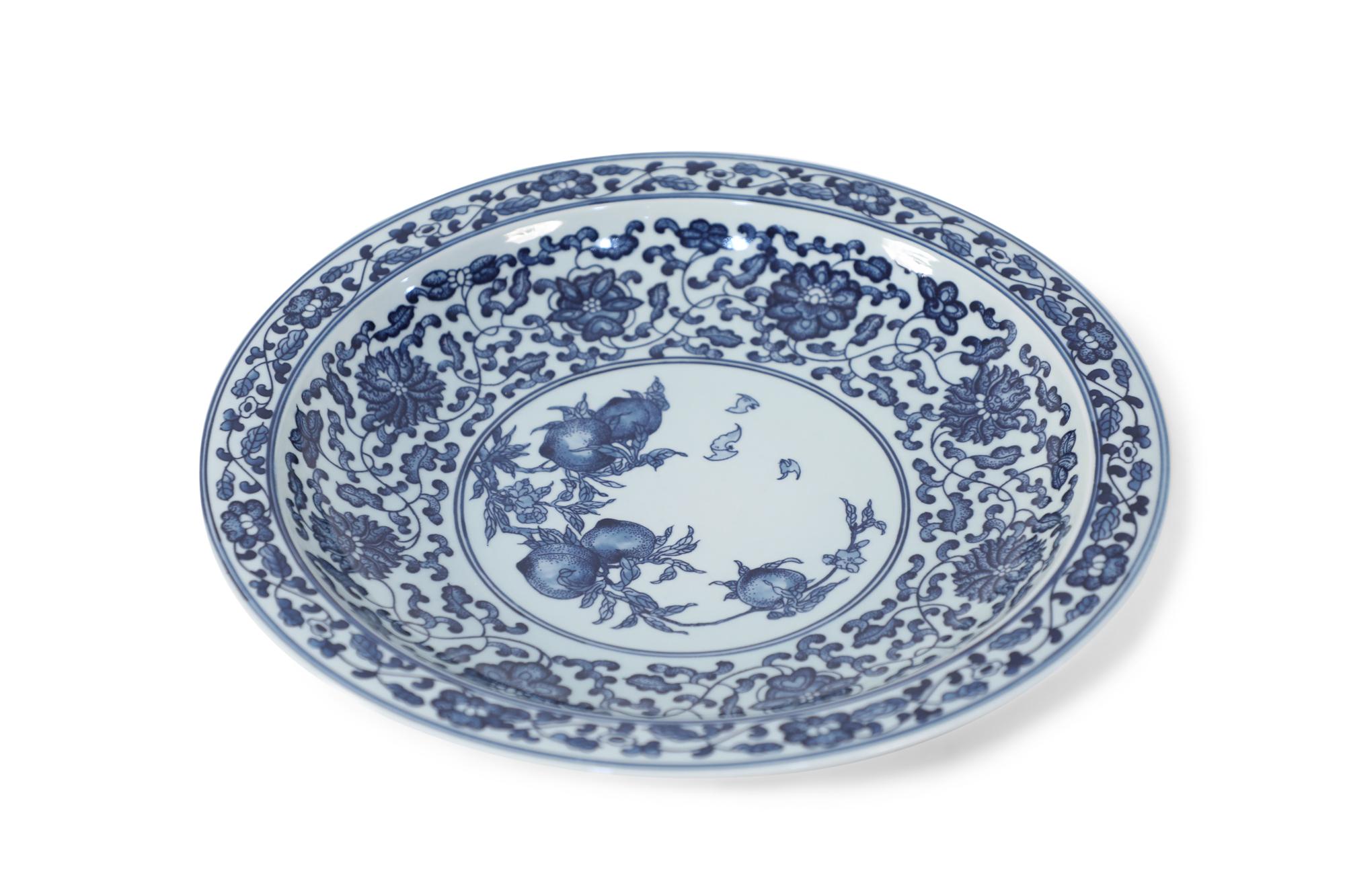 Pair of Chinese blue and white porcelain decorative plates painted with thin blue double lines surrounding floral garlands along the rims, opening to wider florals and swirling vine motifs on the interiors that surround central vignettes of peaches