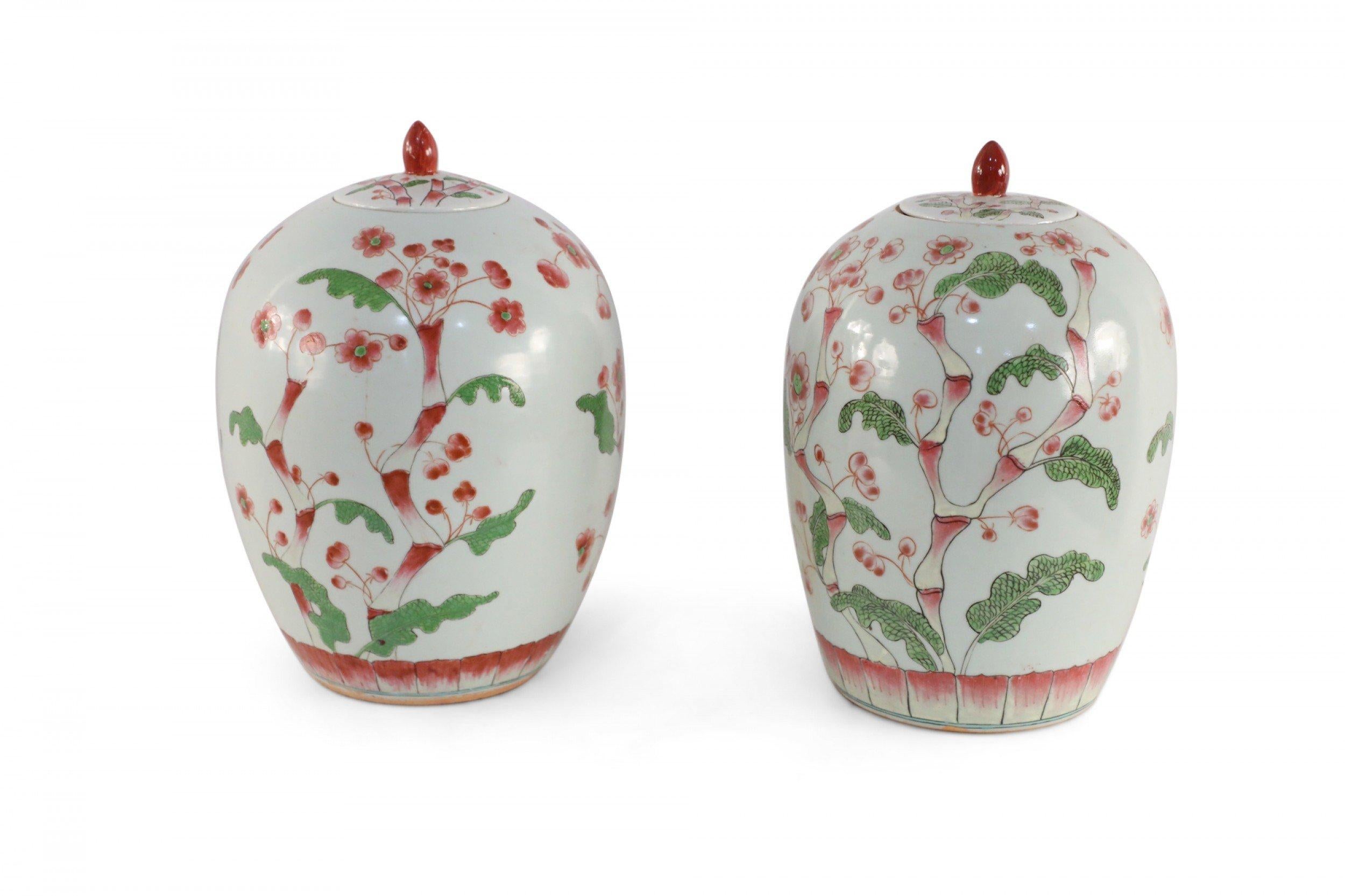 Chinese Export Pair of Chinese White and Pink Cherry Blossom Motif Lidded Porcelain Urns For Sale