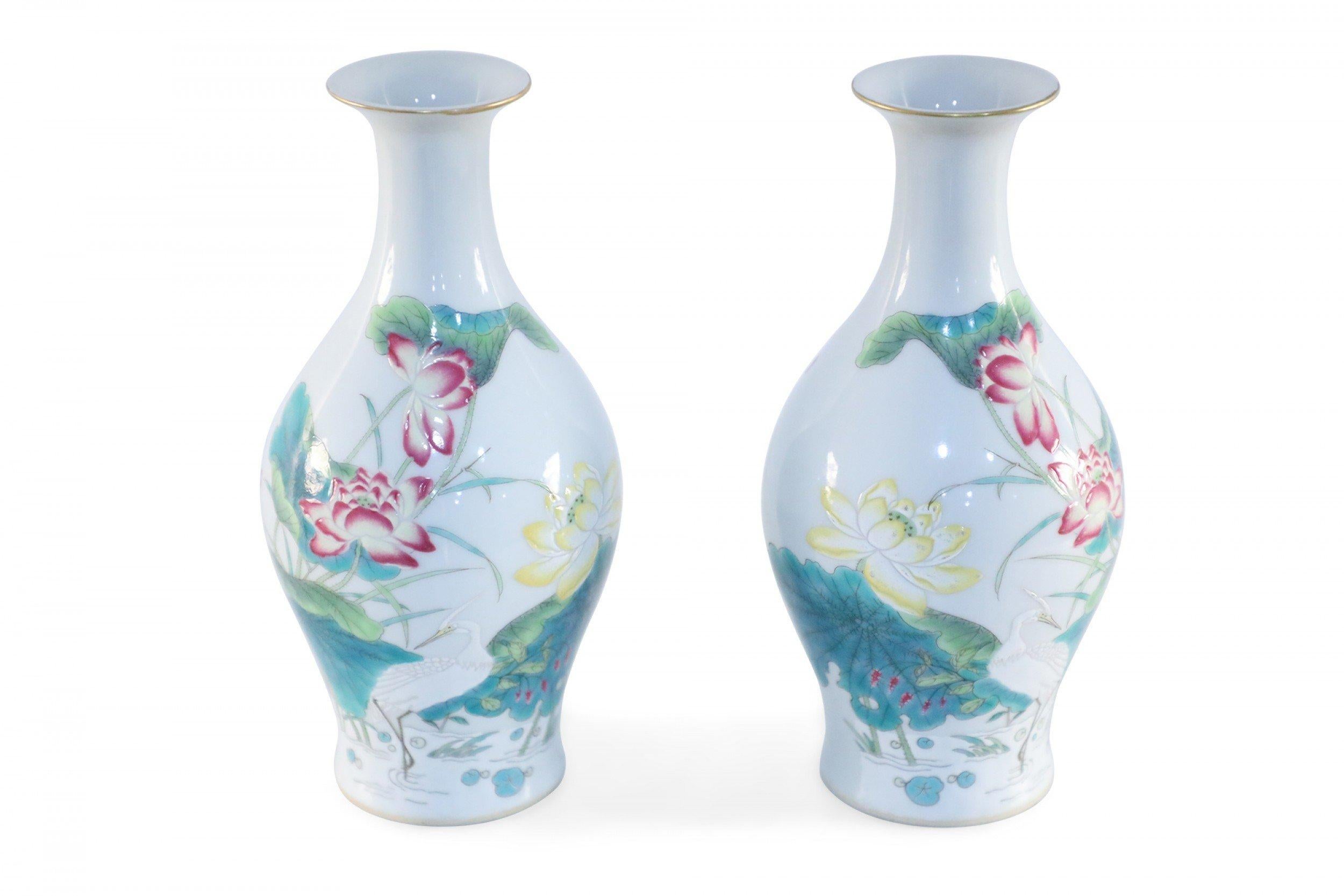 Pair of similar antique Chinese (19th century) famille rose porcelain vases with pear-shaped forms decorated with pink and yellow florals, lily pads, cranes, and gold rims on one side and characters on the reverse (vases differ slightly in pattern)