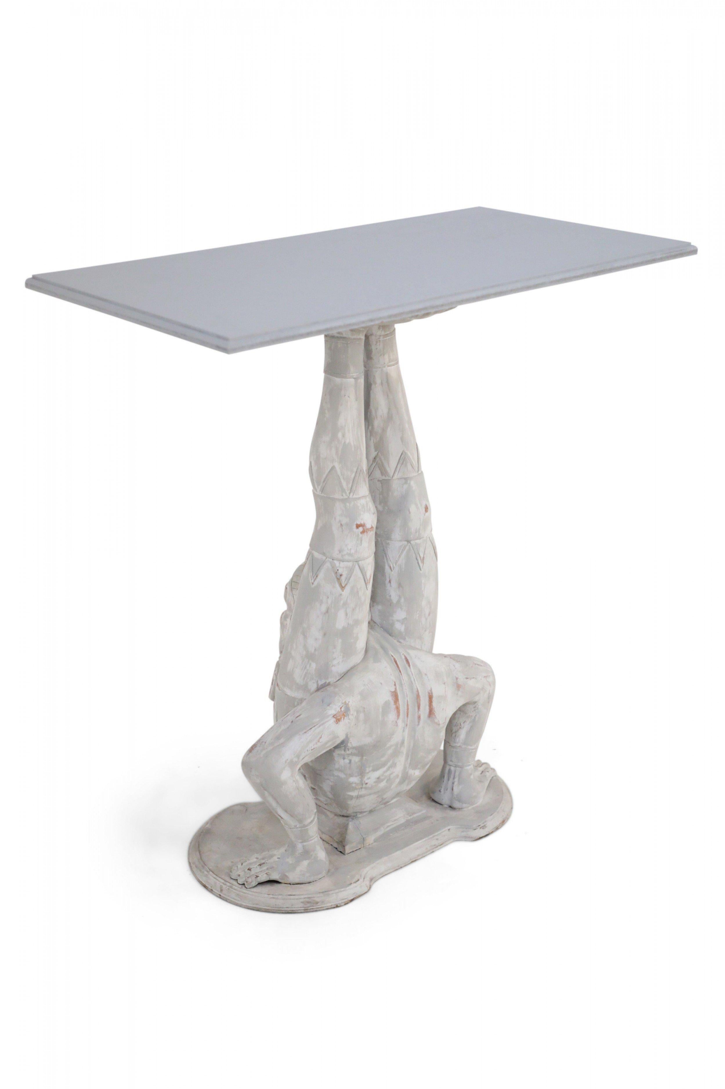 Pair of Chinese console tables comprised of whitewashed wooden bases carved to resemble acrobatic figures supporting gray, rectangular tops (Priced as pair).