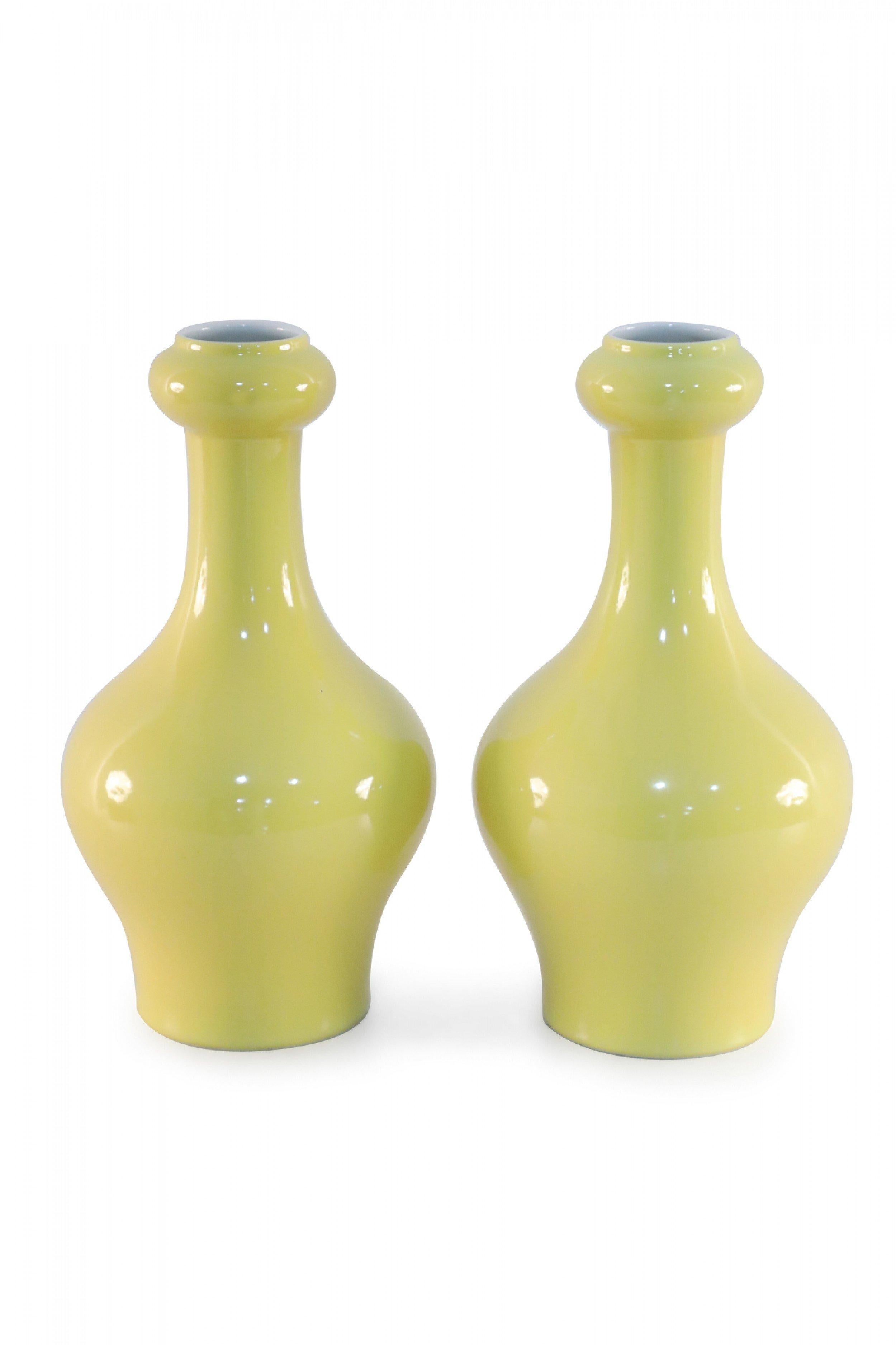 Pair of antique Chinese (late 19th century) yellow porcelain vases with garlic-mouth forms (date mark on bottom, see photos) (priced as pair).
  