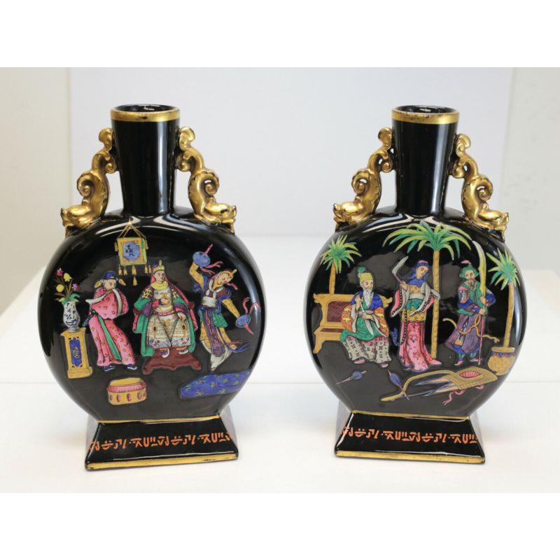 Pair of Chinoiserie Glass & Enamel Hand Painted Moon flasks, c1890

Chinoiserie decorated figurals to the faces of the flasks with inscriptions to the base rim. Attributed to Moser. 

Additional Information:
Primary Material: Glass 
Subject: