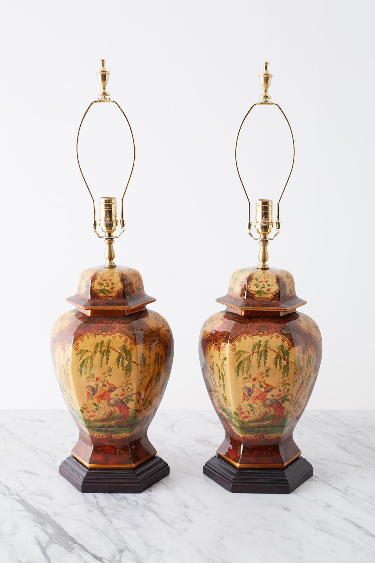 Exceptional pair of chinoiserie glazed ginger jar form table lamps by Bradburn Gallery. The jars having a hexagonal form with a conforming wood plinth. Each jar features beautifully decorated scenes with birds and trees. The urns are topped with