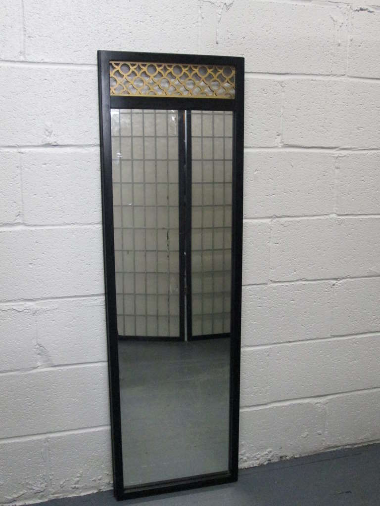 Pair of chinoiserie mirrors in the manner of James Mont. Hollywood Regency. Black lacquered wood frames with gold decorative molding to the top.
 