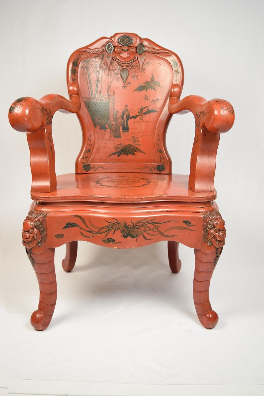 A pair of chinoiserie red lacquered and carved armchairs decorated with figurines.
 