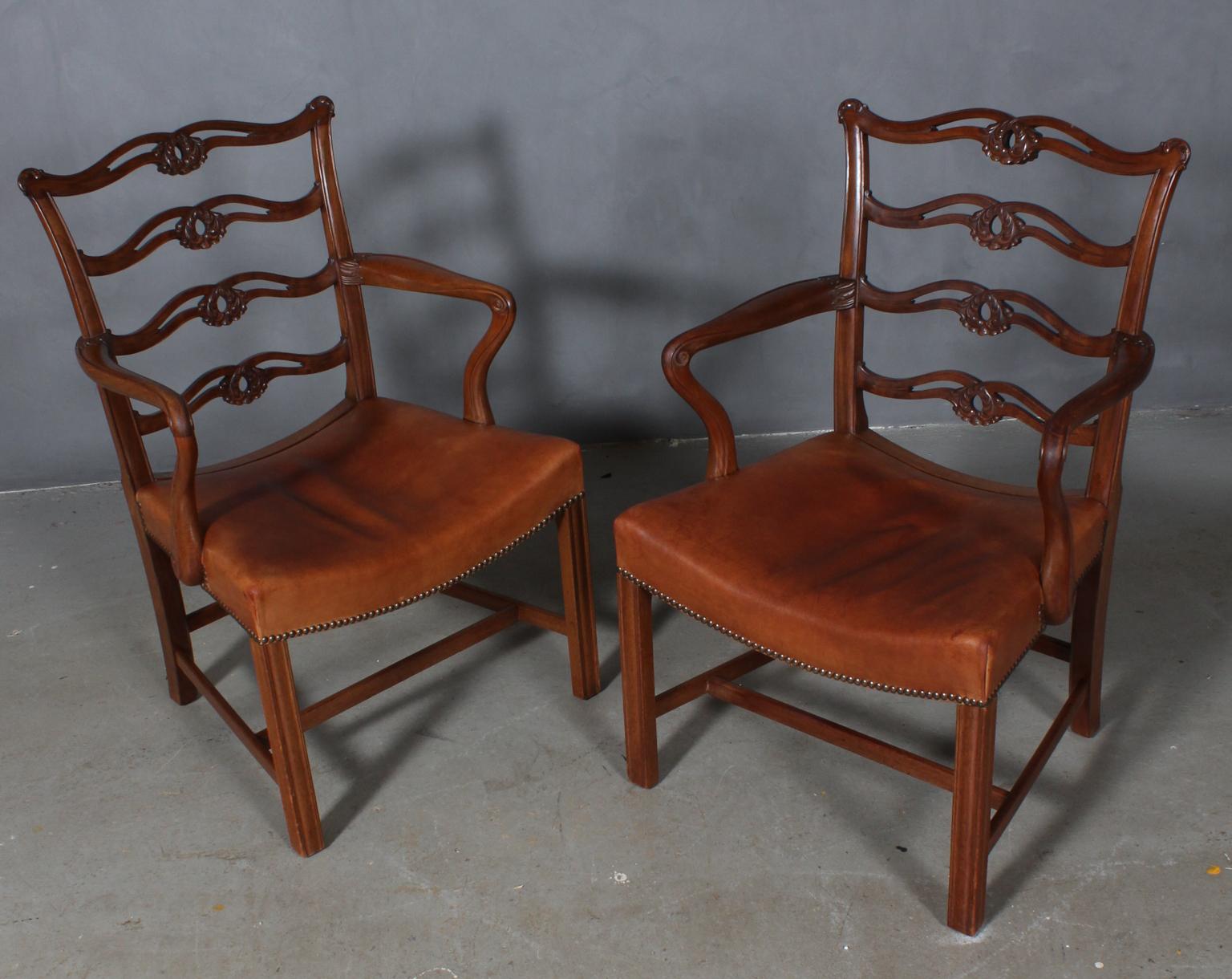 Pair of Chippendale style armchairs with rich details. Made in mahogany.

Original upholstered with patinated leather. 

Made in Denmark, circa 1900.