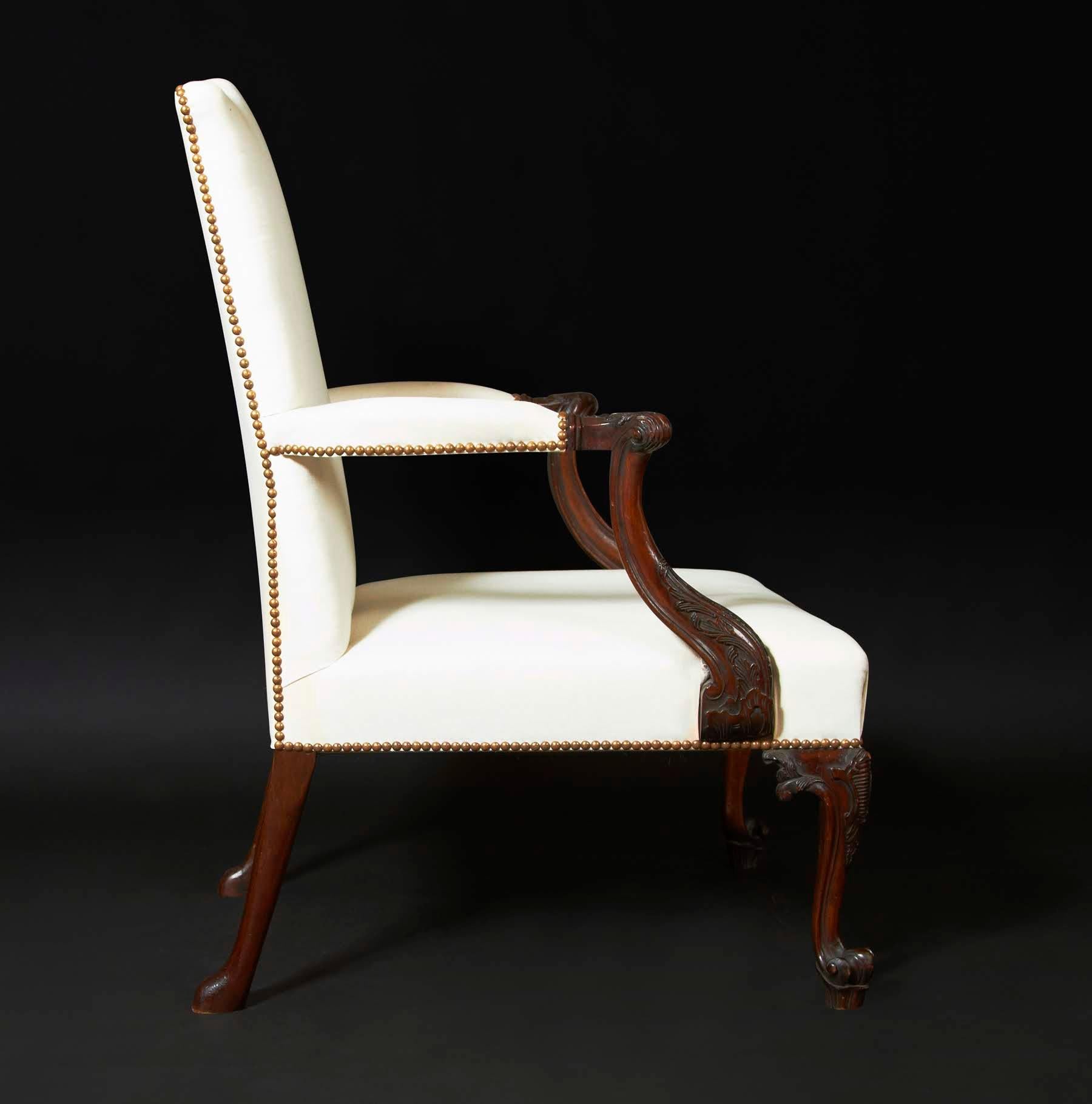 The Chippendale Gainsborough armchair. This handsome carved mahogany library or “Gainsborough” armchair has a gently curving back and shaped arms that have acanthus leaf carved scrolled handles and leaf carved molded supports. The padded seat is