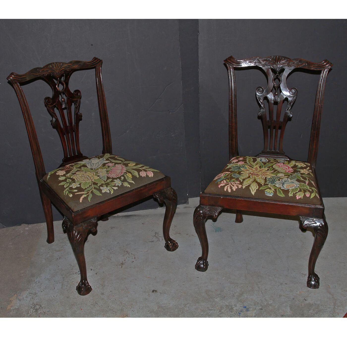 A pair of George II Chippendale carved mahogany side chairs, with a shell carved and scroll eared crest rail, rare tassel and rope motif carved splat, shell carved knees, and ball and claw feet. English, Ca 1760's.

Dimensions: 22