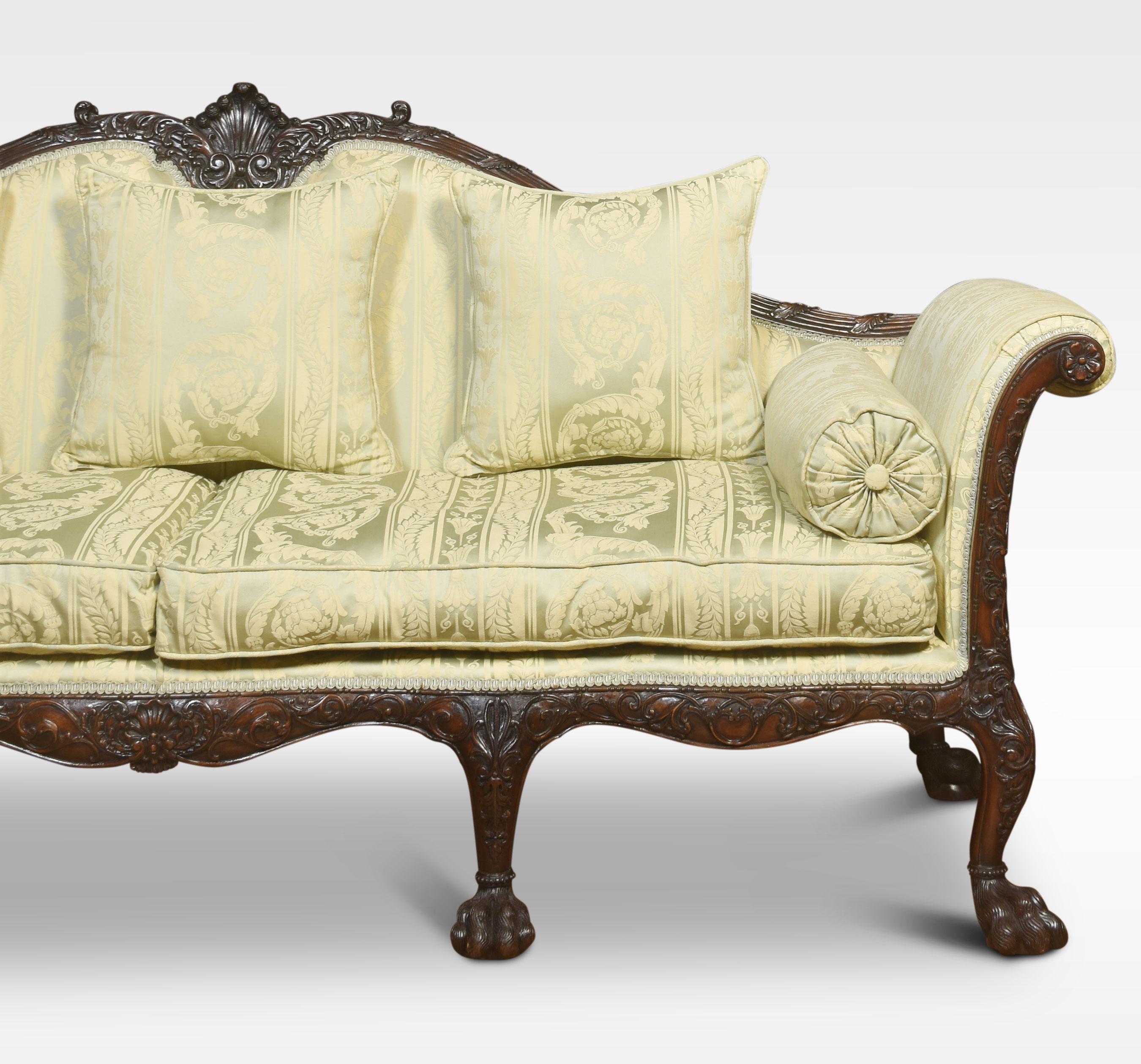 Pair of Irish Chippendale revival sofas, The profusely carved mahogany frames, upholstered in a pale green silk damask, with squab cushions & bolsters. The settees having shaped backs to the scroll arms and serpentine fronts with foliate & anthemion