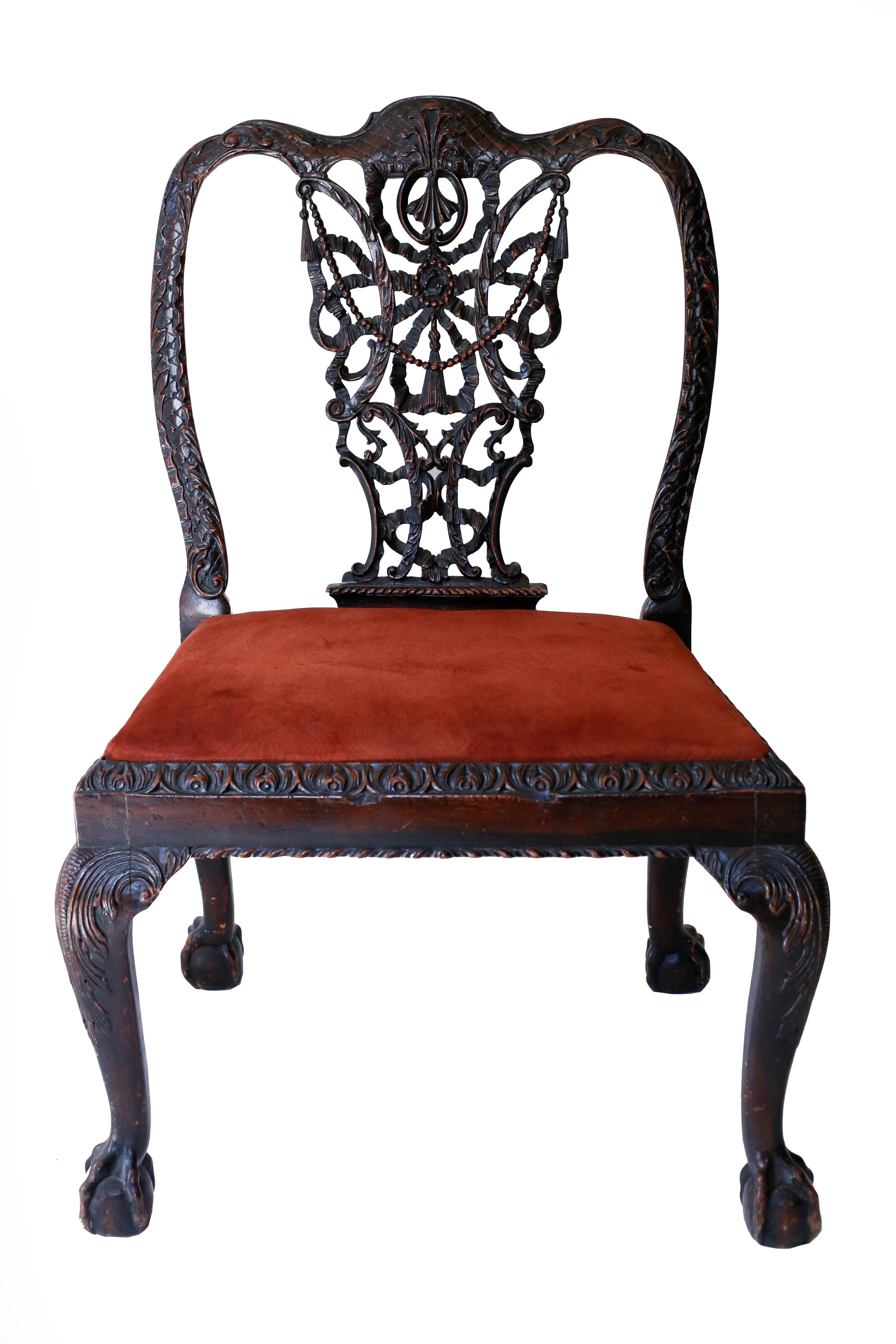 A exuberantly carved pair of intricate pierced splat chairs rooted in the designs of Thomas Chippendale for a 