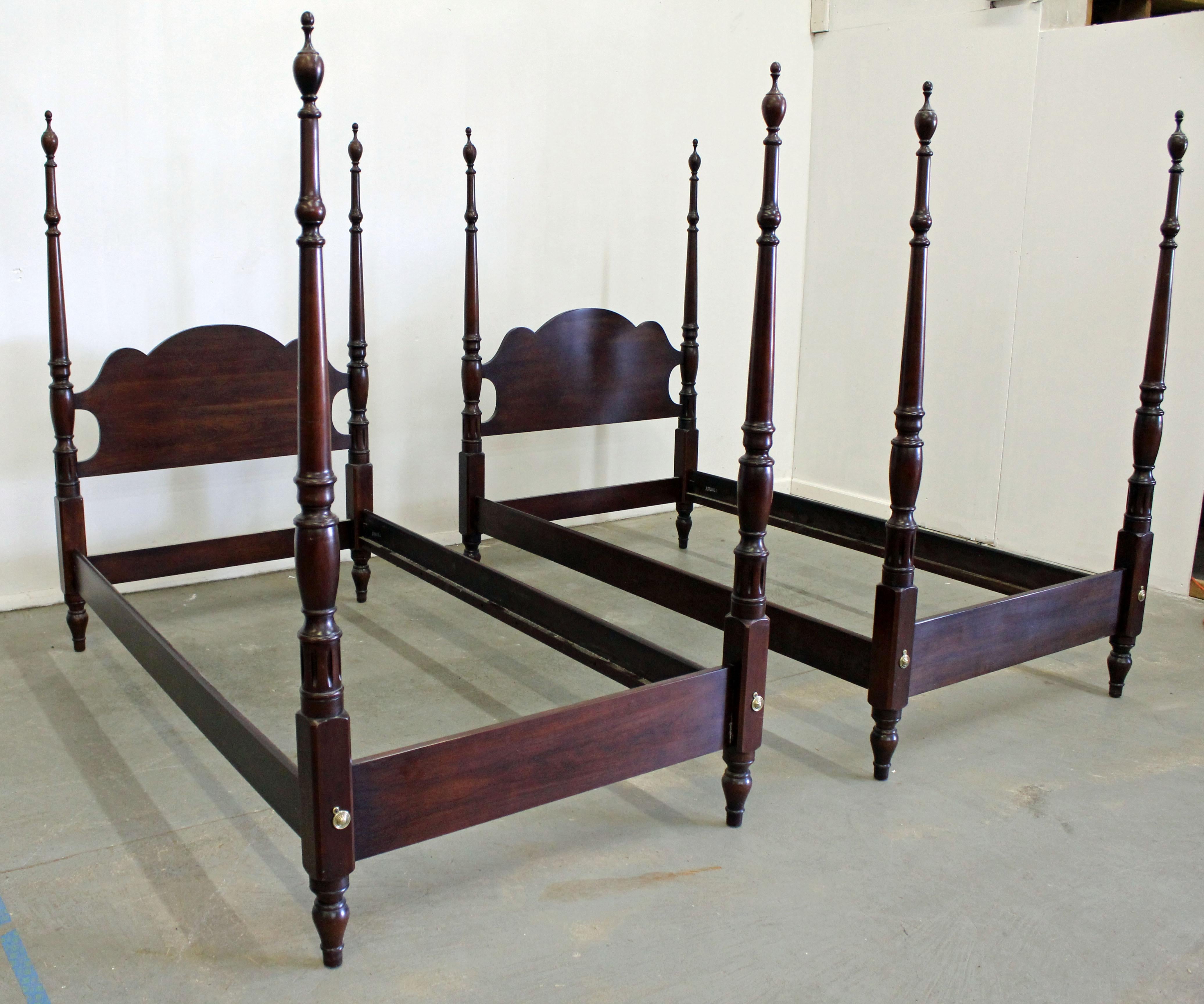 Offered is a pair of vintage Chippendale twin size beds by Statton 'Old Towne'. Includes two bed frames with slats, both made of cherry with four posters. In good, structurally sound condition with some age wear. This piece came out of a local