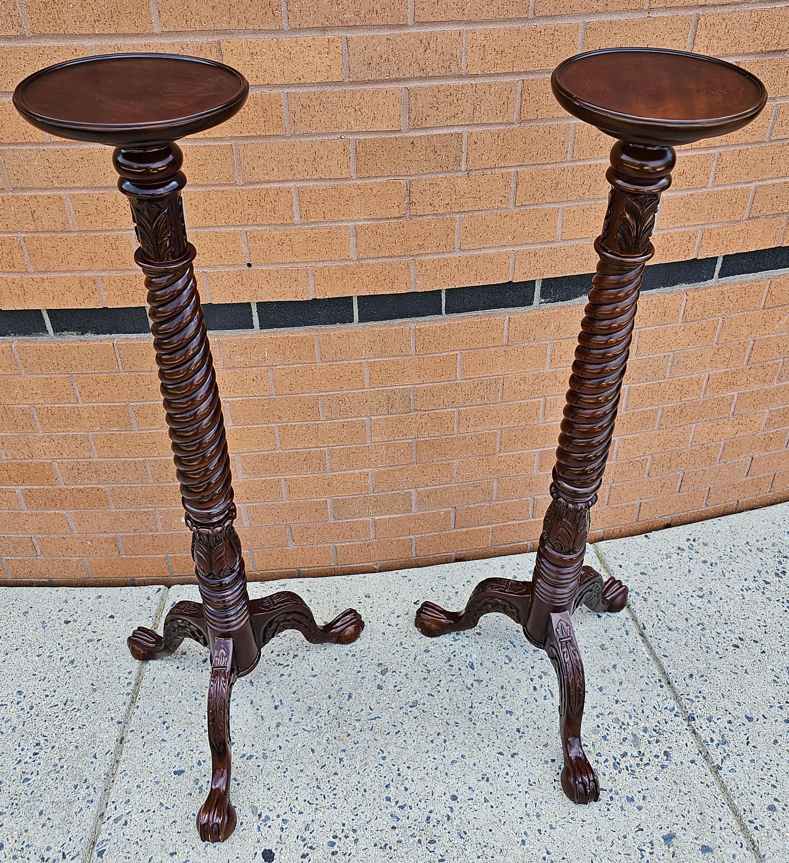 An exquisite Pair of Chippendale Style Carved and Stained Mahogany Stands with Ball Claw Feet in great condition. Measures at the base 20