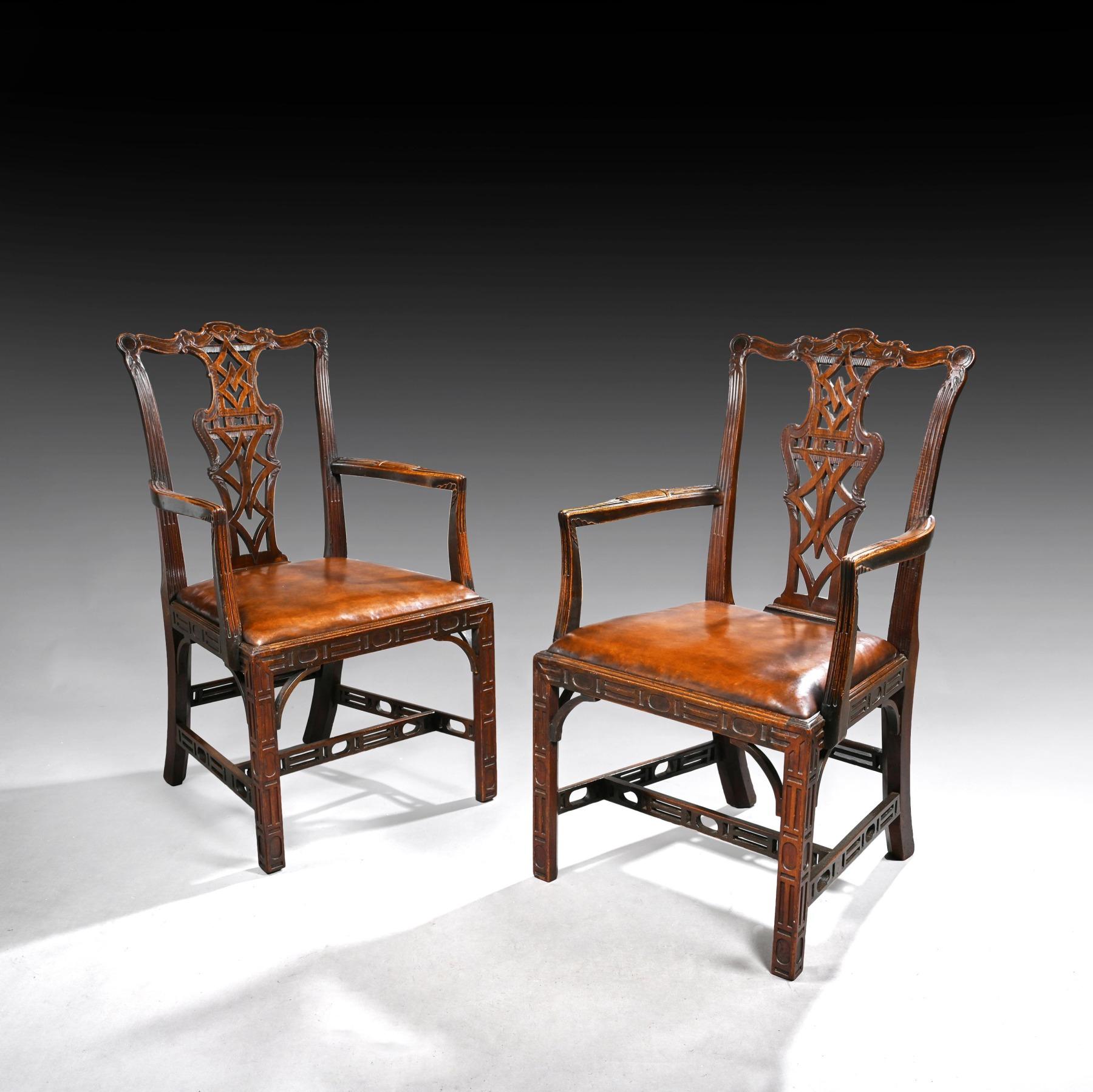 A fine pair of Chippendale style mahogany and leather armchairs with crisply carved back splats and pierced stretchers. 

English Circa, 1910.

These well designed armchairs are ascetically pleasing and the craftsman has used a very good choice