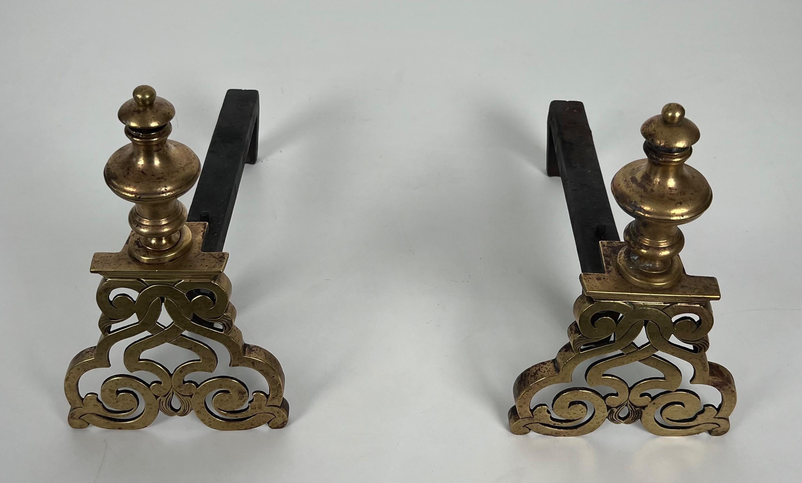 This pair of andirons is made of chiseled bronze and wrought iron. This is a French work in the Louis the 15th style. Beginning of 19th century