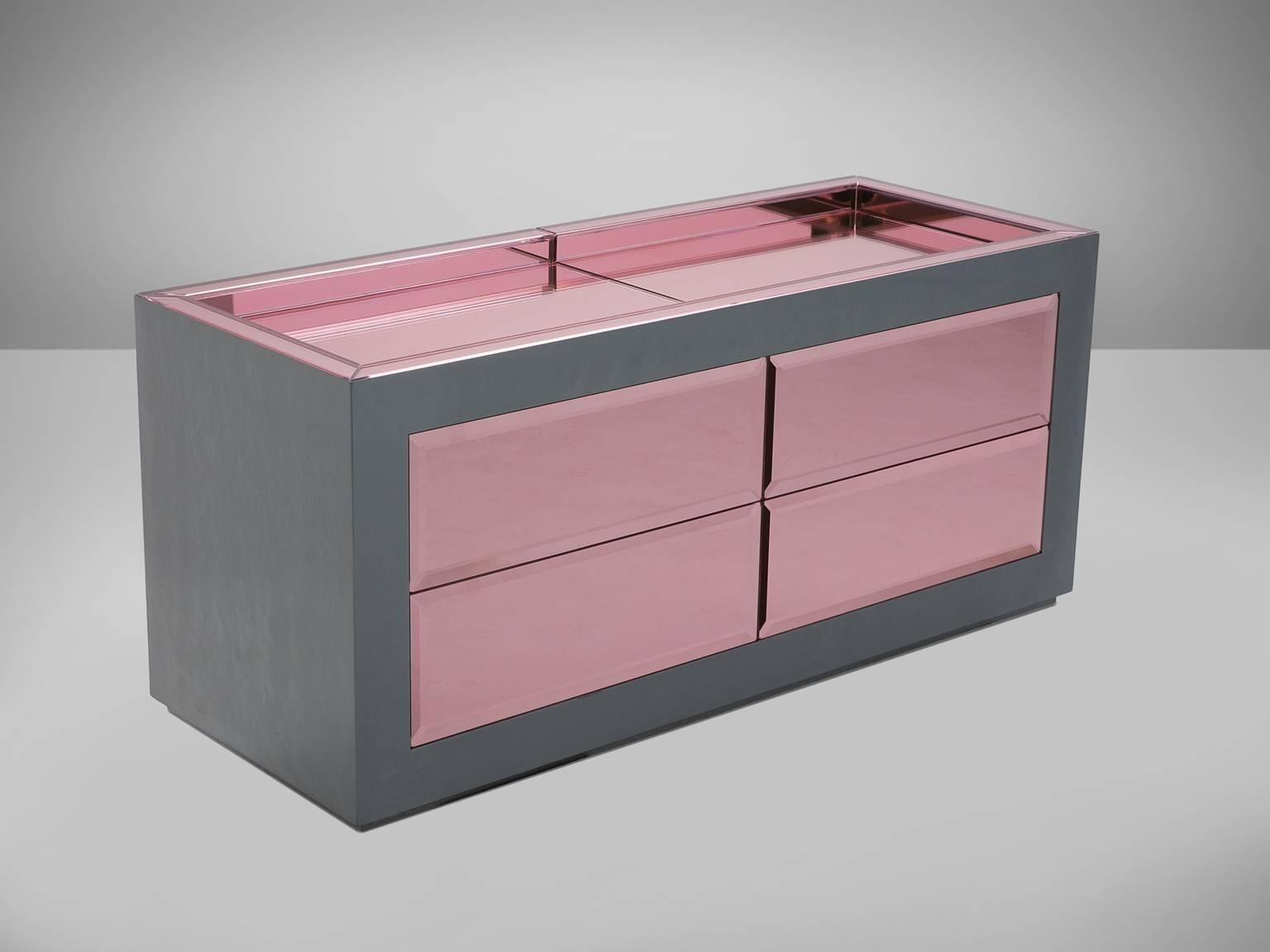 Christian Lacroix, pair of sideboards, pink and grey glass, Europe, 1970s.

Covered with pink and transparent silver colored glass, this decorative shop counter is a true eye-catcher. Equipped with four drawers with 'push' mechanism to provide an