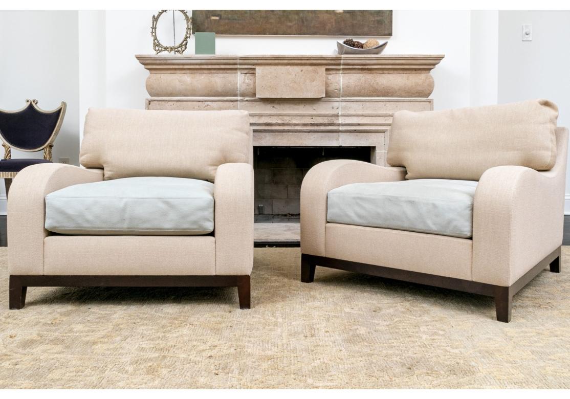 Pair of lounge chairs designed by Christian Liaigre for Holly Hunt with sloop arms The high-quality craftsmanship is evident in the meticulous attention to detail, from the elegantly tapered legs to the plush, comfortable leather seating. The chairs