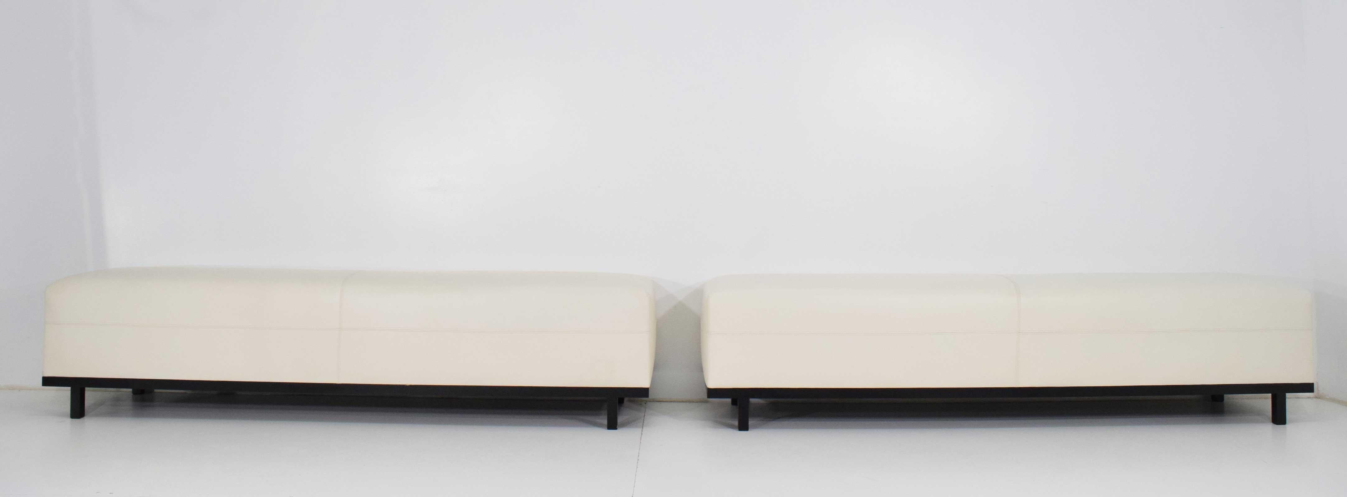 Beautiful pair of Christian Liaigre Nankin benches in white leather, black lacquer bases. These can be sold individually.