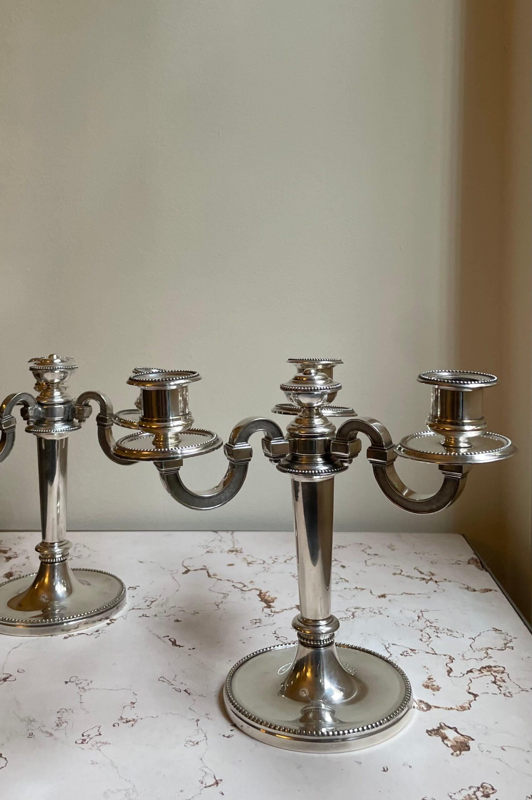 Pair of Christofle candlesticks with three arms of light decorated in Louis XVI style. France, 1950s.