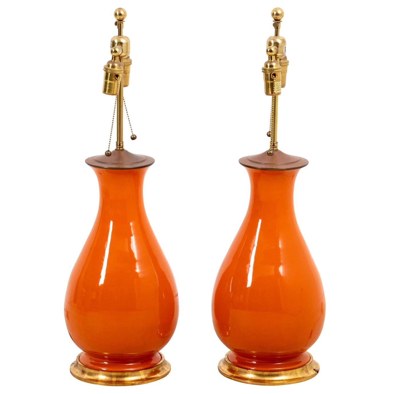 Pair of Christopher Spitzmiller vintage large Hana orange lamps on gold gilded bases with brass double sockets, circa 2012. Signed with turquoise lable-c.2012. Made in the United States. Please note of wear consistent with age including minor patina