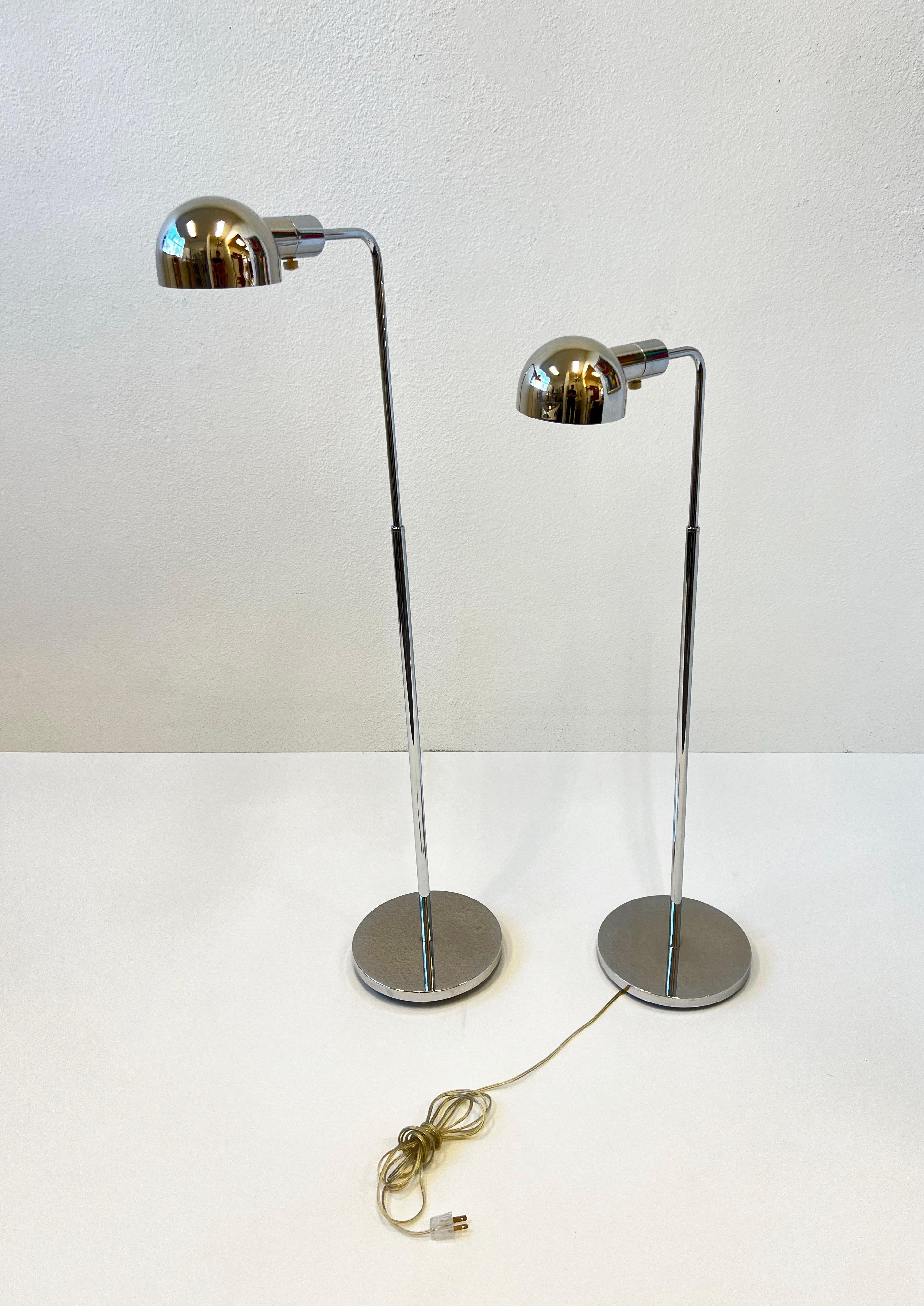 1980’s polish chrome adjustable floor lamps by Casella Lighting. 
In good original vintage condition, shows minor wear consistent with age. The lamps are dimmable and take one 75w max Edison light bulb. 
49.5” High when all the way up, 33.5” High