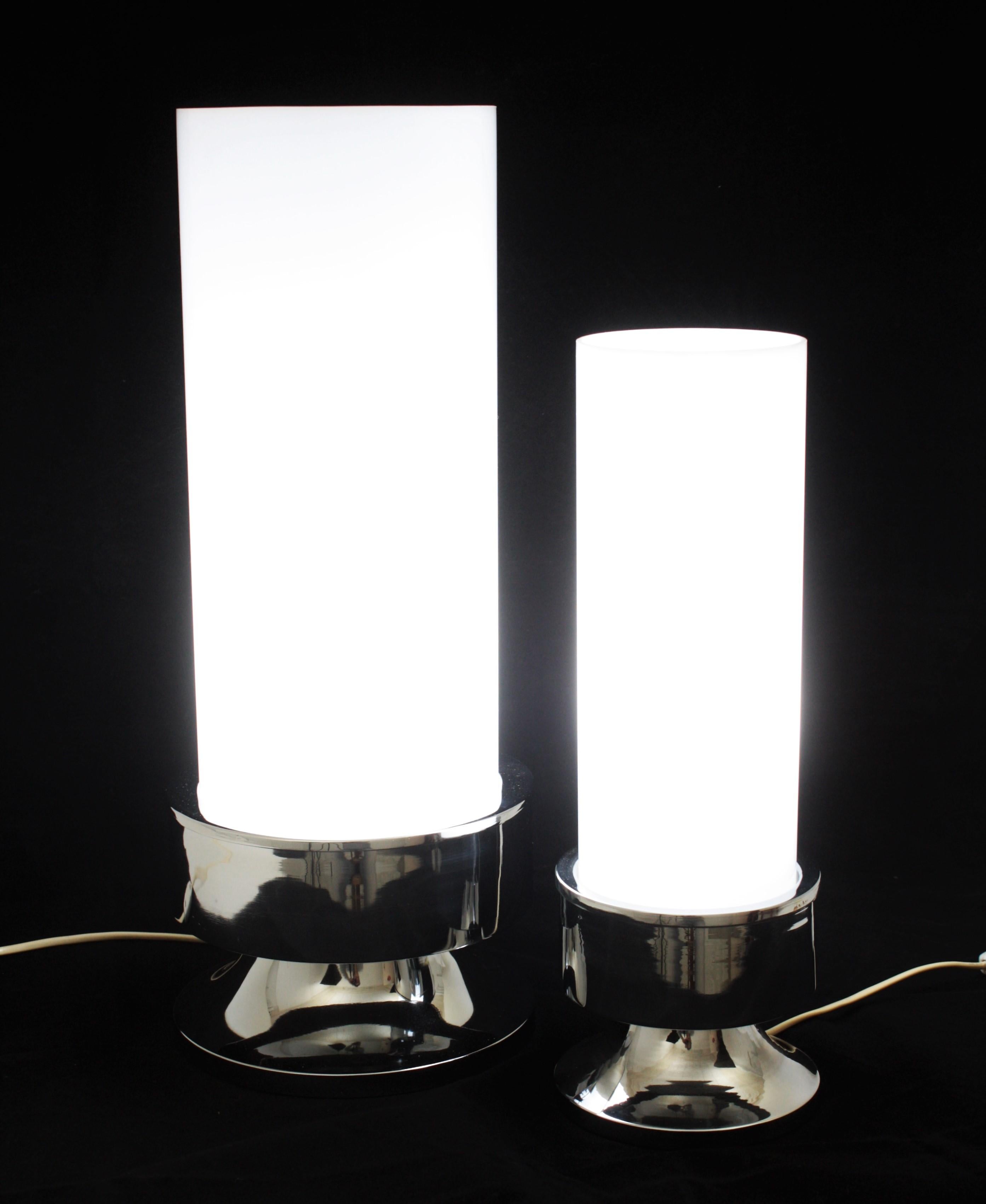 Conjunto de lámparas de sobremesa de acrílico y cromo de diseño Space Age, Italia, años 60.
Las lámparas tienen una pantalla cilíndrica acrílica blanca que se alza sobre una base de acero cromado. Uno es más grande que el otro.
Quedan bien colocados