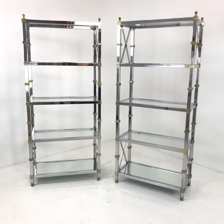 Glamorous pair of French Directoire style chrome and brass Midcentury étagères/shelves. Made in the 1970s.
