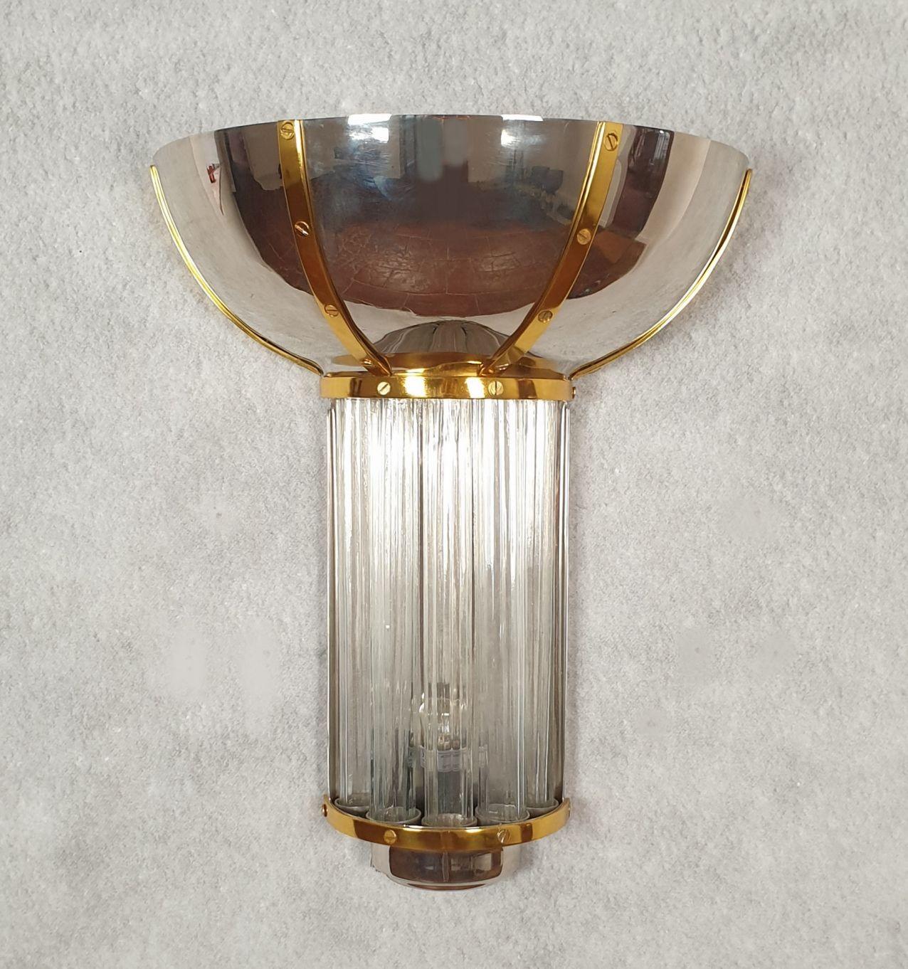 Large Mid Century wall sconces, attributed to Jean Perzel, France circa 1960 or earlier.
Set of ten sconces available. Sold and priced by pair.
The vintage sconces are made of chrome, brass and glass tubes.
They have a light behind the tubes and 2