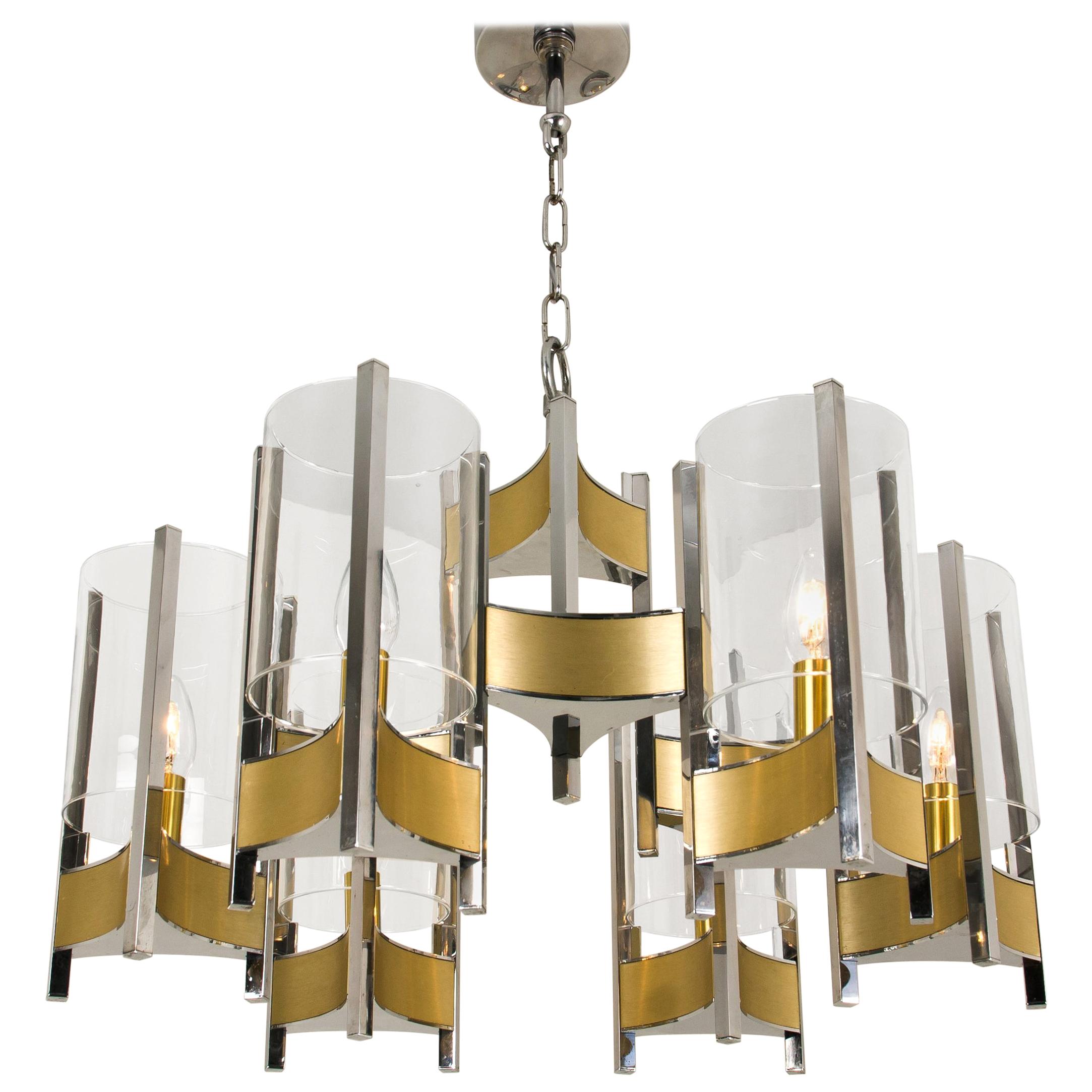 Pair of Gaetano Sciolari chrome and brushed brass six-light chandeliers with cylindrical glass shades, stylish monumental Sciolari chandelier. Consist of three arms with 6 glass cylinders. Chrome and brushed brass base.

Cleaned and well-wired, in