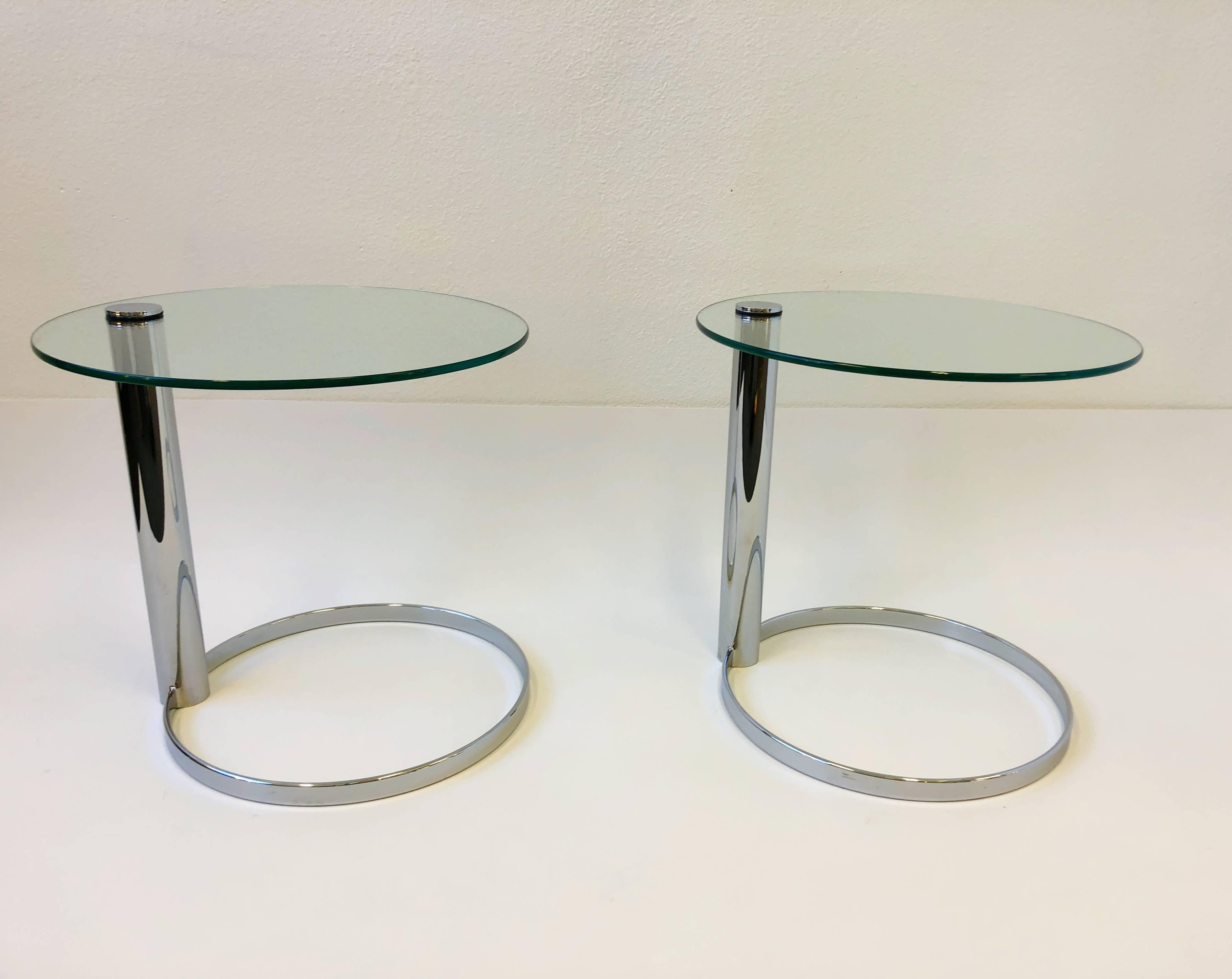 A amazing pair of polish chrome and glass side tables by John Mascheroni for Swaim. New glass tops. Dimension: 22” diameter, 21” high.  
 