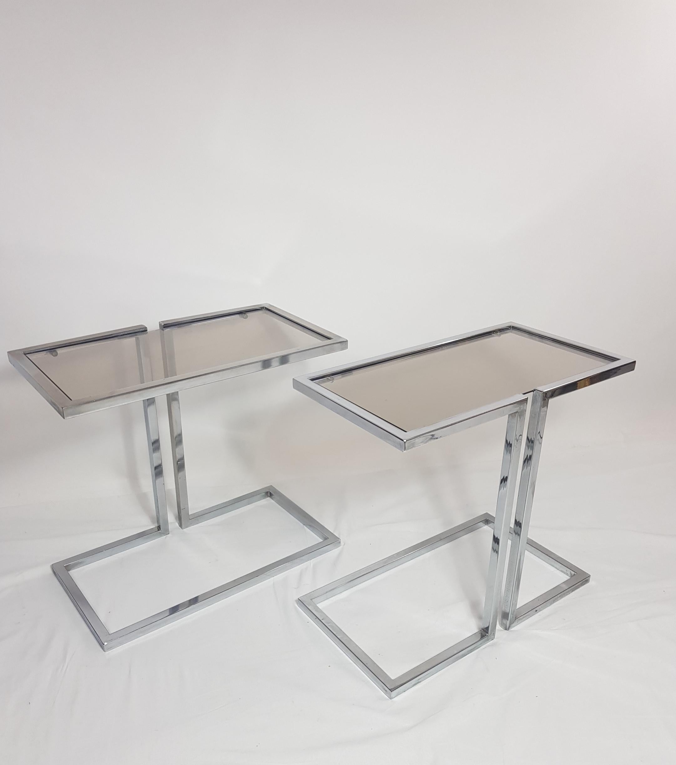 Elegant pair of chrome sofa side tables with smocked glass top.
Can be combined in many ways and used as side tables or coffee tables. 
1970s.
 