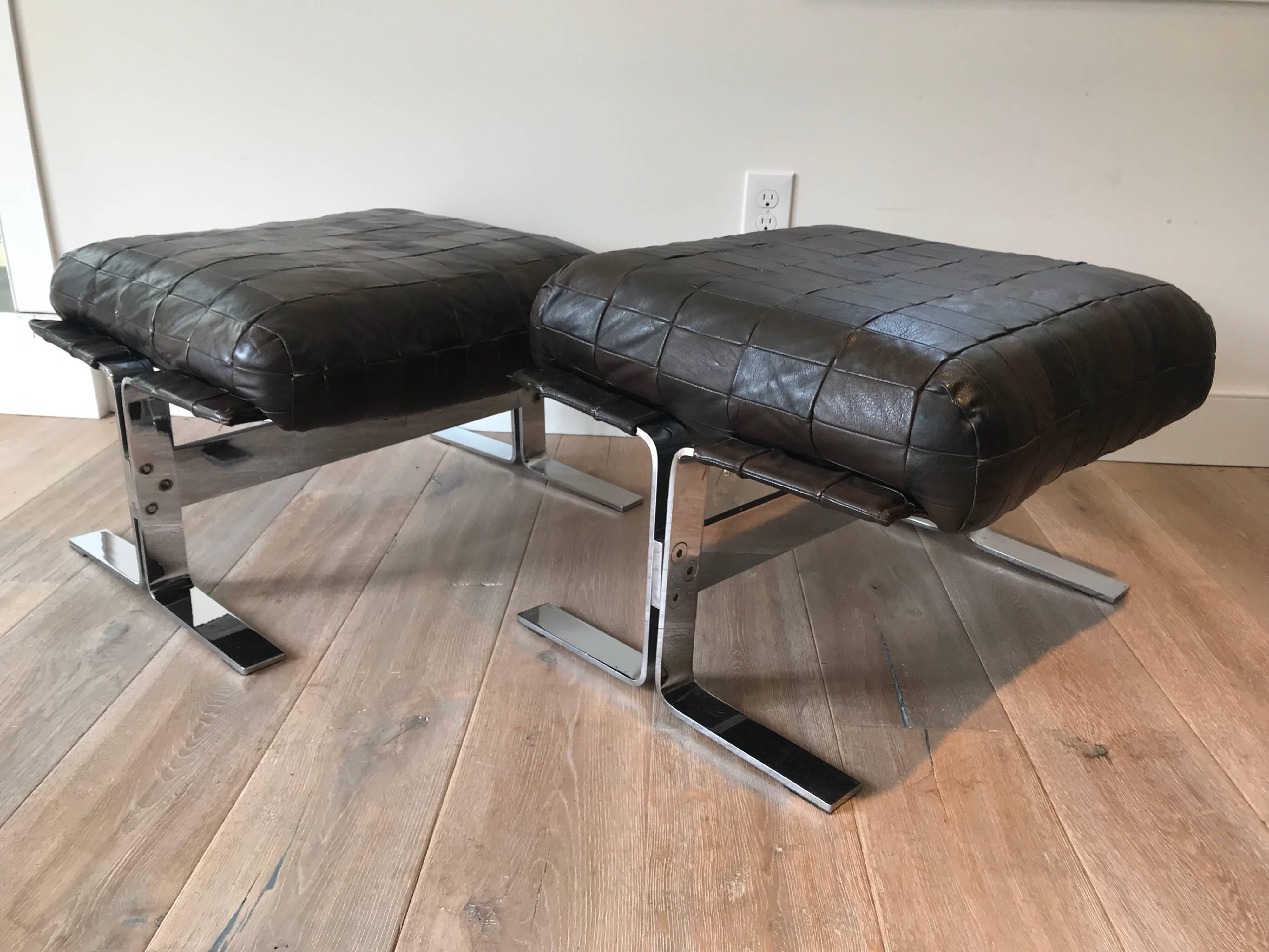 Pair of chrome frame ottomans with brown patchwork leather cushion. Designed by Kipp Stewart for Pace.