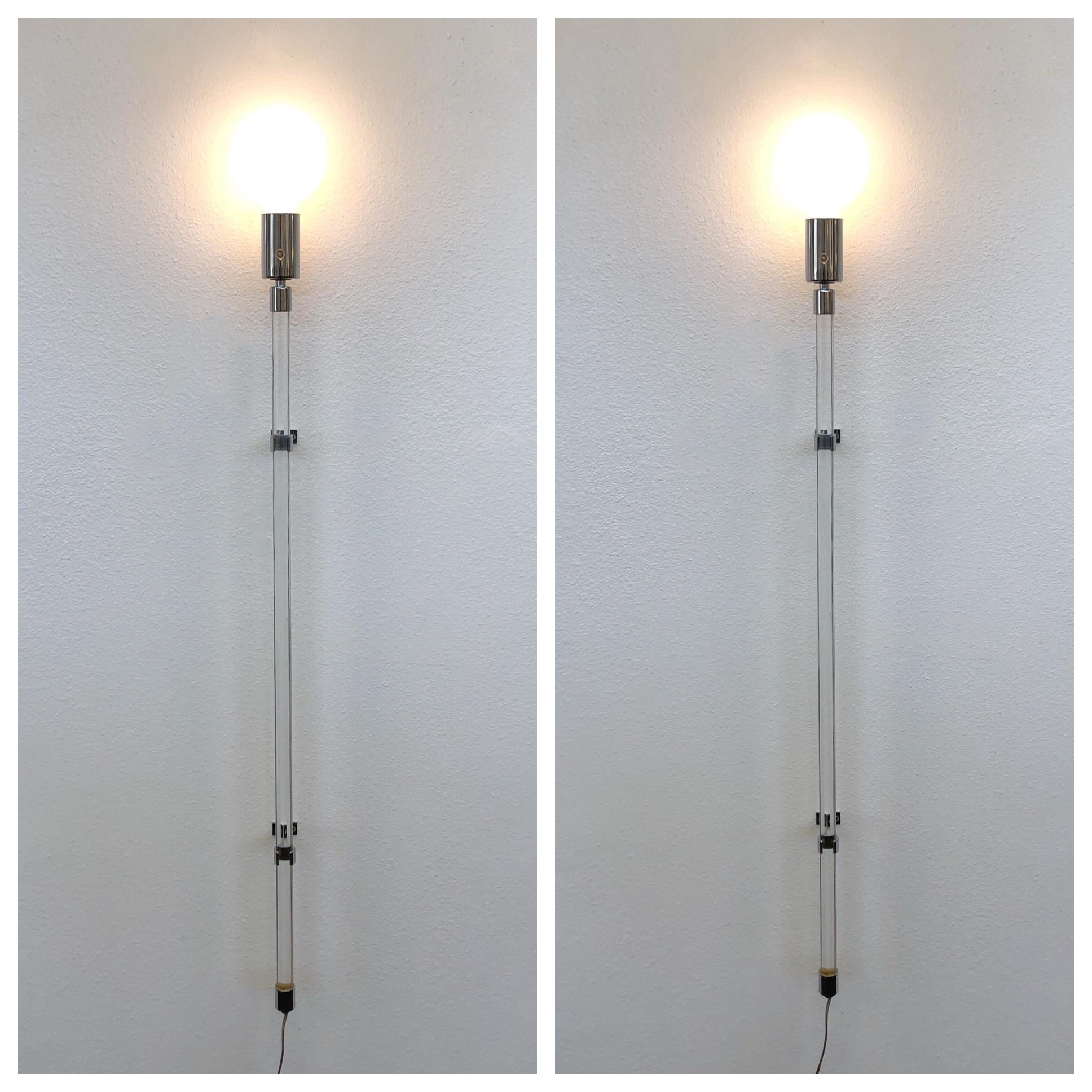 A spectacular pair of chrome and acrylic wall sconces design by Peter Hamburger for Knoll International in the 1970s.
Dimensions with large bulb: 51” high 6” deep 5” wide.