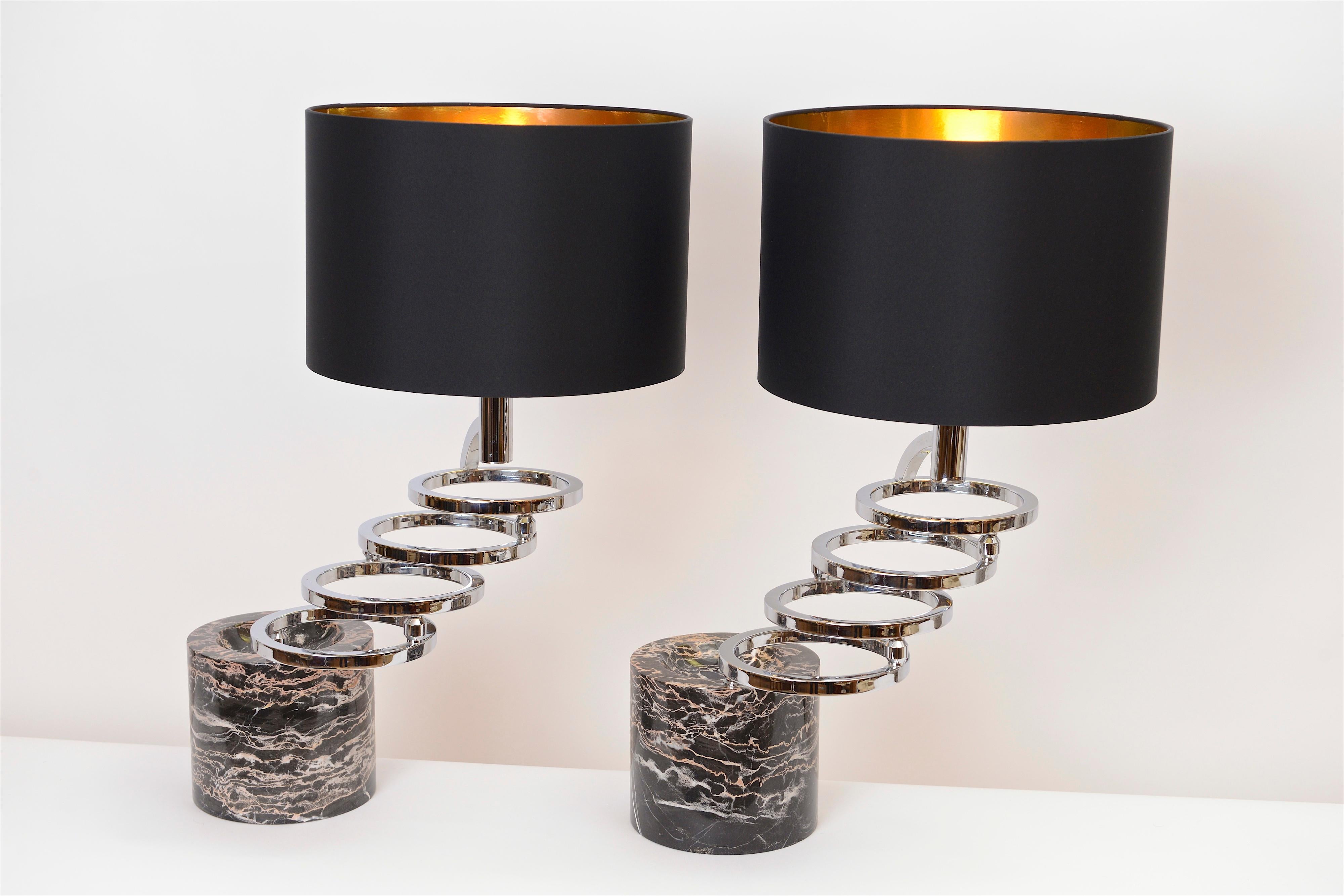 A fantastic pair of chrome and marble table lamps from the Florentine designer Giovanni Banci. Produced in the 1970s, these substantial lamps have a rare and beautiful marble base that features a concave cut-out on its surface. Its four chromed