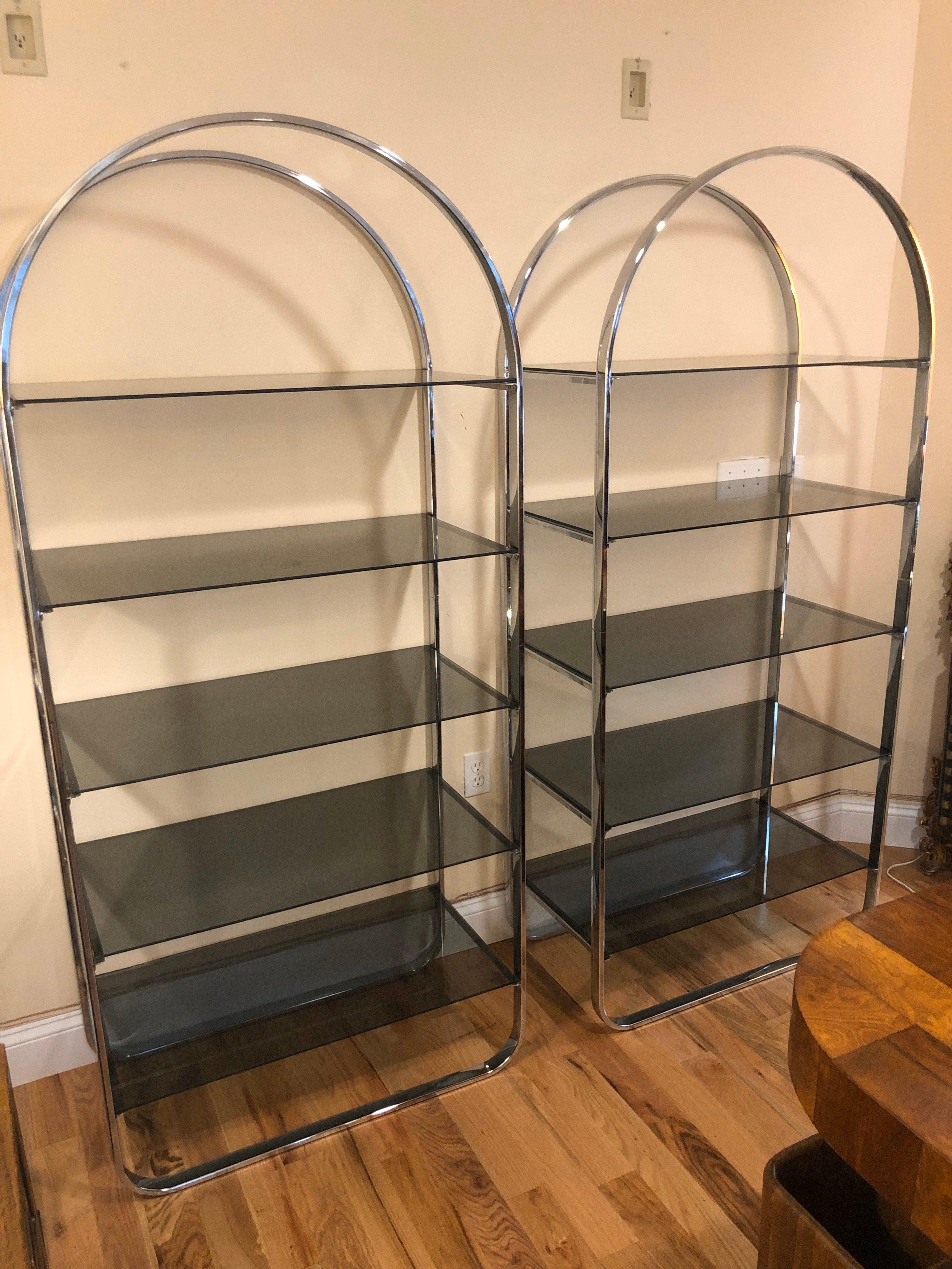 Price is for the pair.
Pair of chrome and smoked glass étagères. Five shelves each or 10 shelves total for display or storage.  Sleek and sexy these would make any room look good. In the style of Milo Baughman. Perfect Minimalist look for office,
