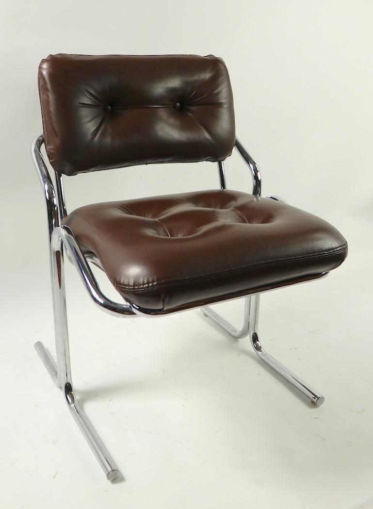 Chic pair of tubular chrome and brown vinyl chairs designed by Jerry Johnson for Landes Furniture. Quintessential 1970s Art Deco Revival style, clean, original and ready to use condition. Offered and priced as a pair.
 