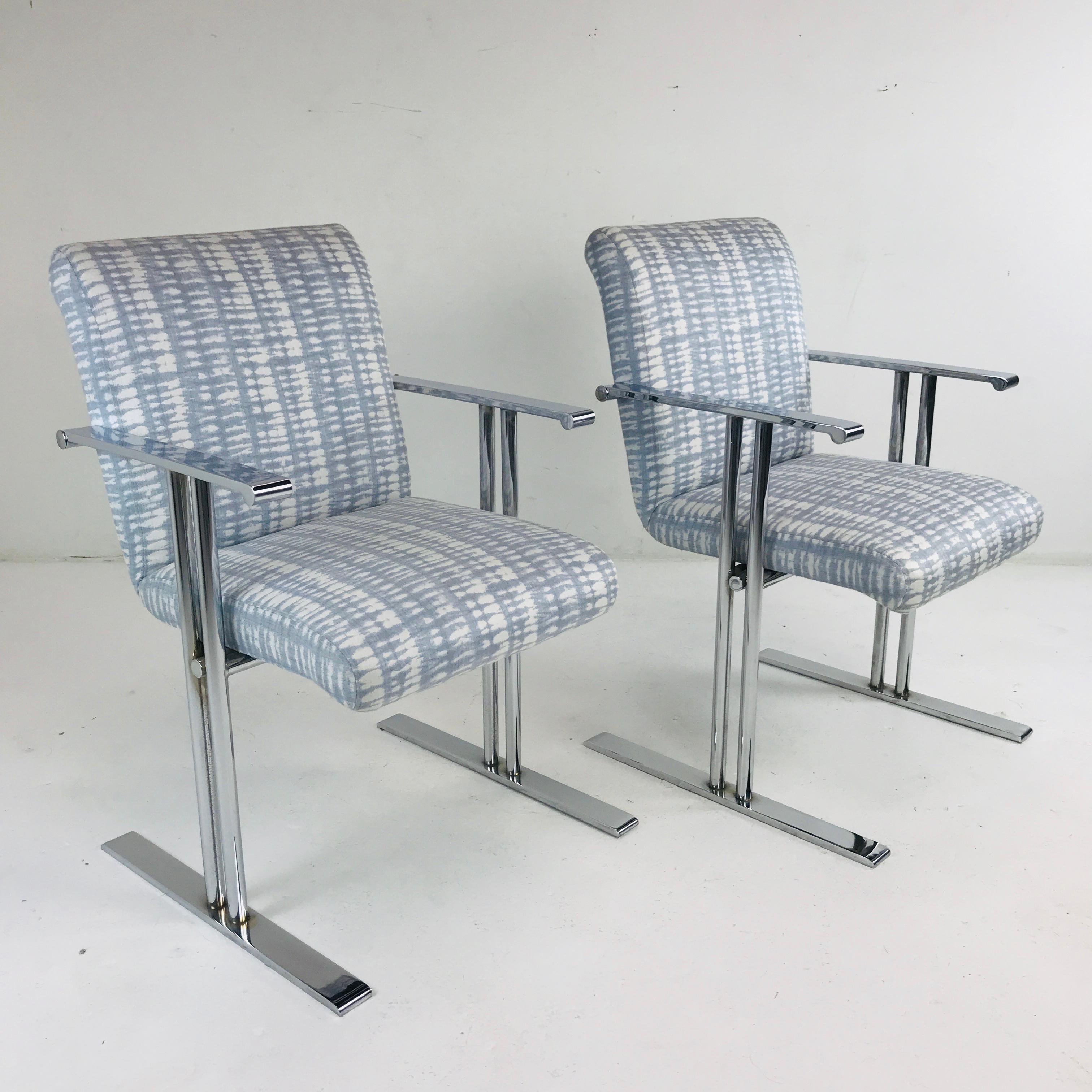 Pair of chrome armchairs by Directional with strong lines poised on steel bases, in the style of Milo Baughman. New upholstery.