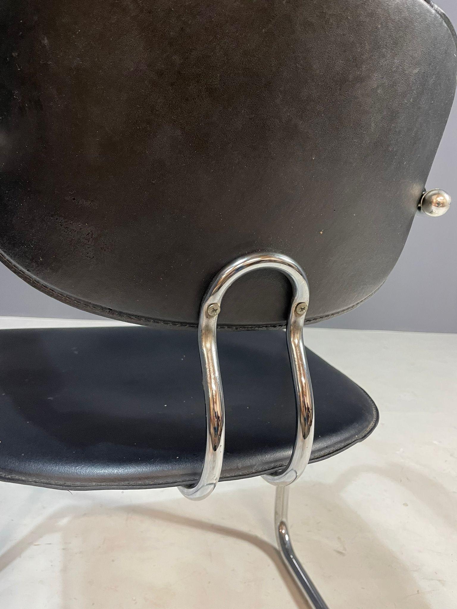 A pair of chrome Bauhaus-style chairs designed by Italian brand Effezeta in the 1980s. These chairs combine a cantilevered chrome frame with black plastic seating and backrest. The elegant curved lines evoke mid-century modernist and functionalist