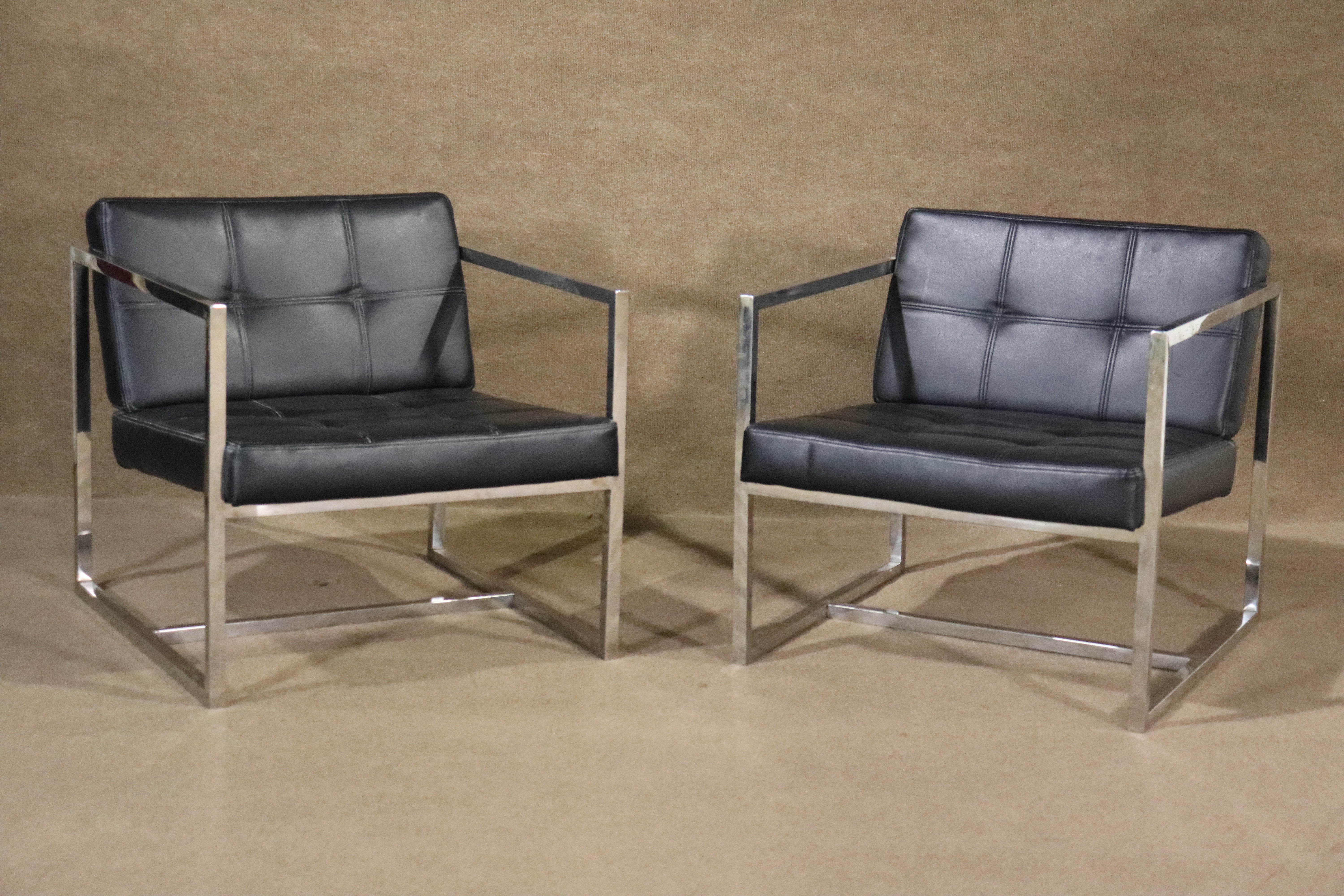 Bring home this gorgeous blend of form and function with two elegant polished chrome and leather lounge chairs. With a robust polished chrome base and tufted leather to boot, these leather chairs are a great fit for home or office. 

Please confirm