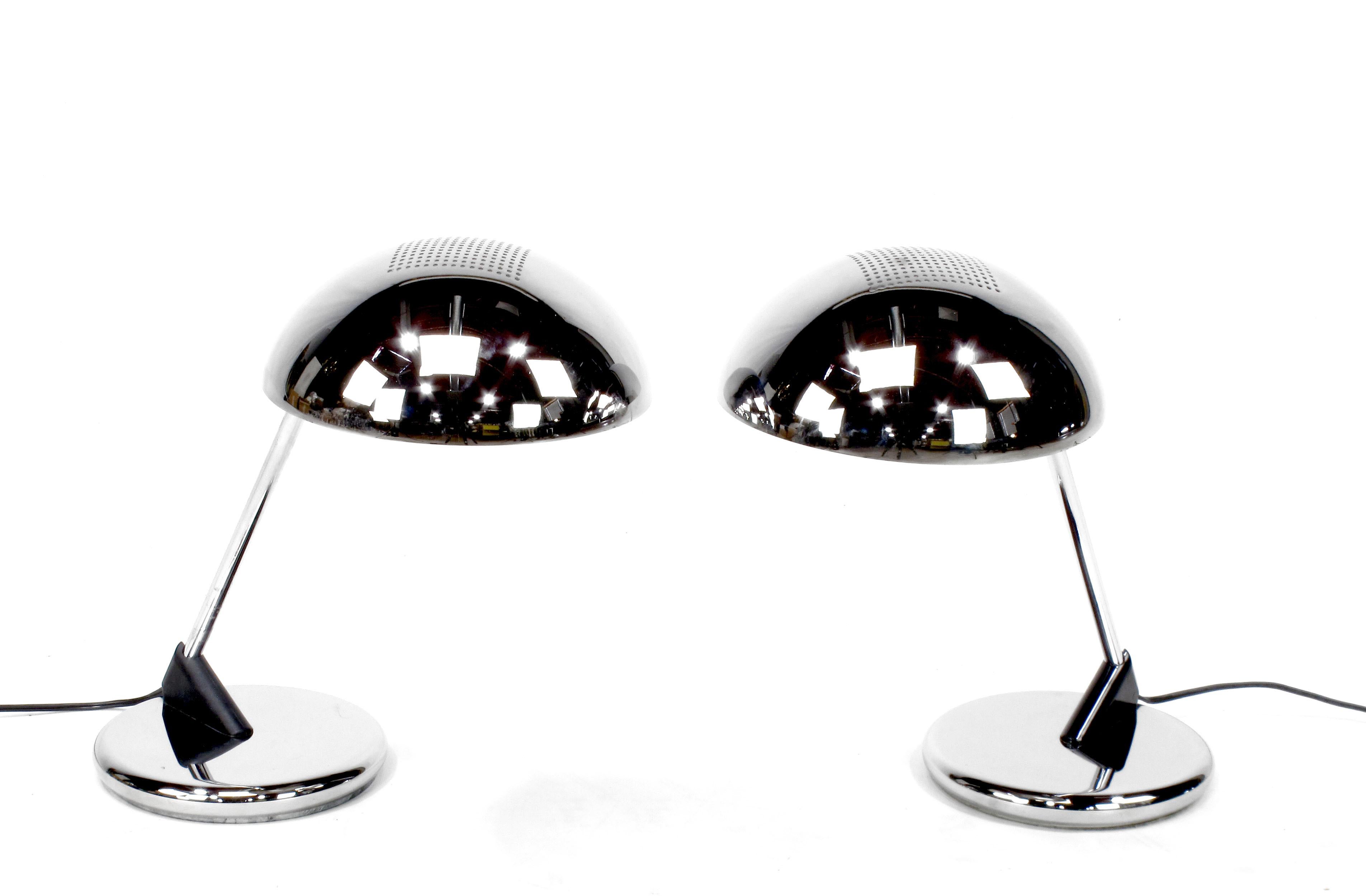 Uncommon pair of chromed steel desk lamps with cantilever dome shade and weighted base, circa 1960s, these are the only pair we have been able to find. They could possibly be Italian or German. Either way they are a fantastic looking pair of desk